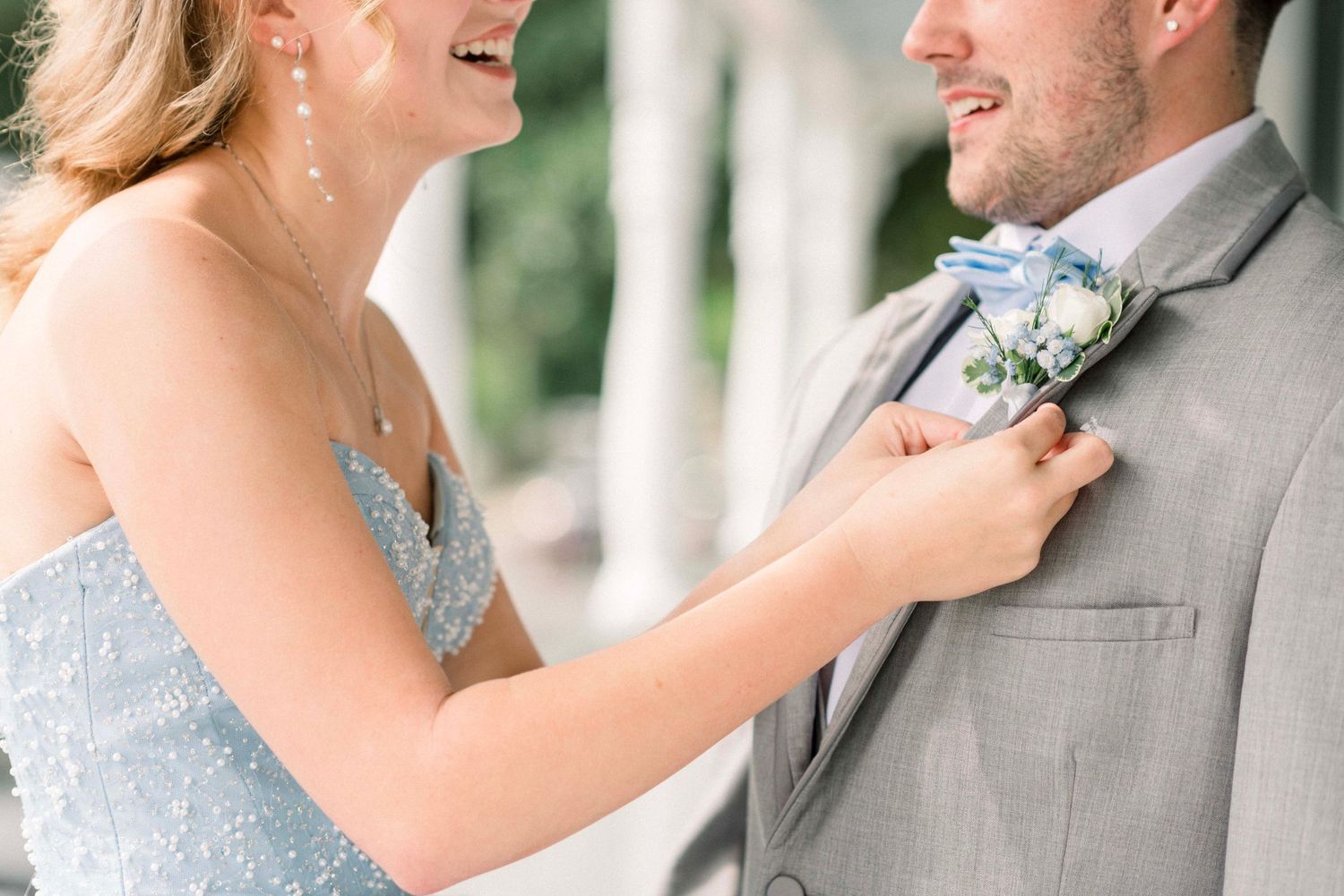 Close-up shot of a couple sharing a joyful moment in formal attire.