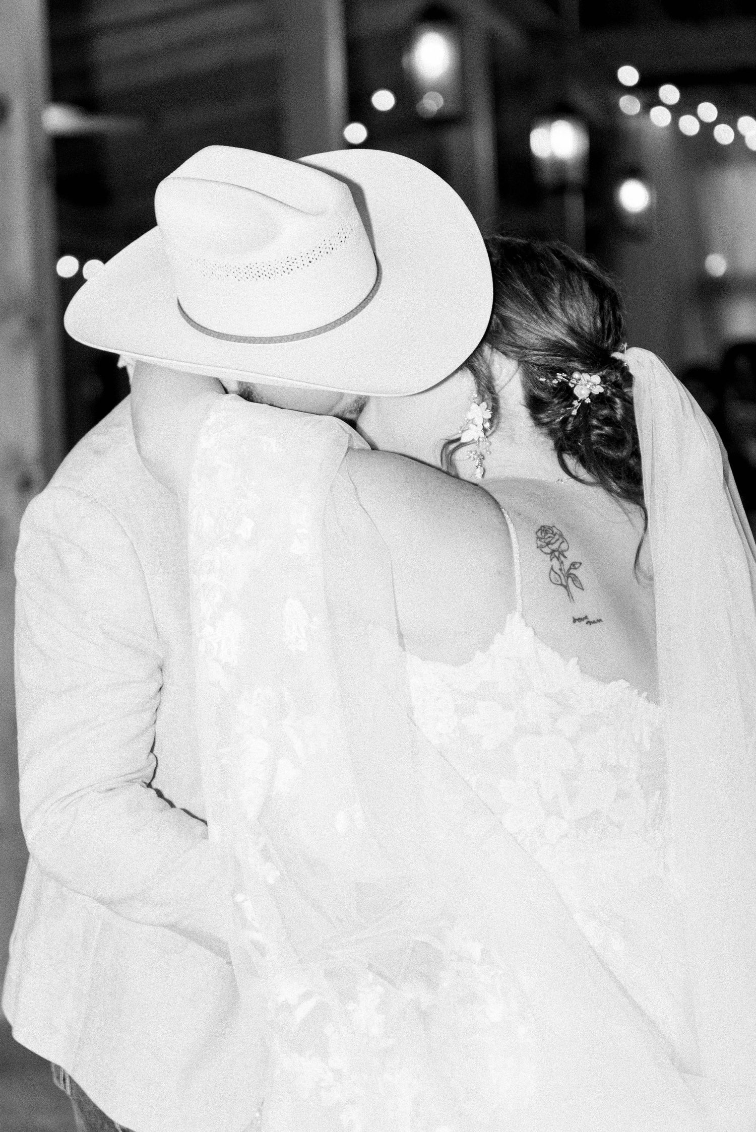 Black and white photos of flowing white wedding dress details in evening light.