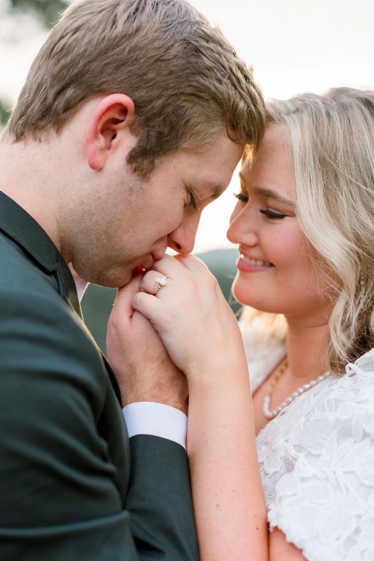 A romantic sequence of engagement photos showing tender moments between a couple in formal attire in the Smoky Mountains