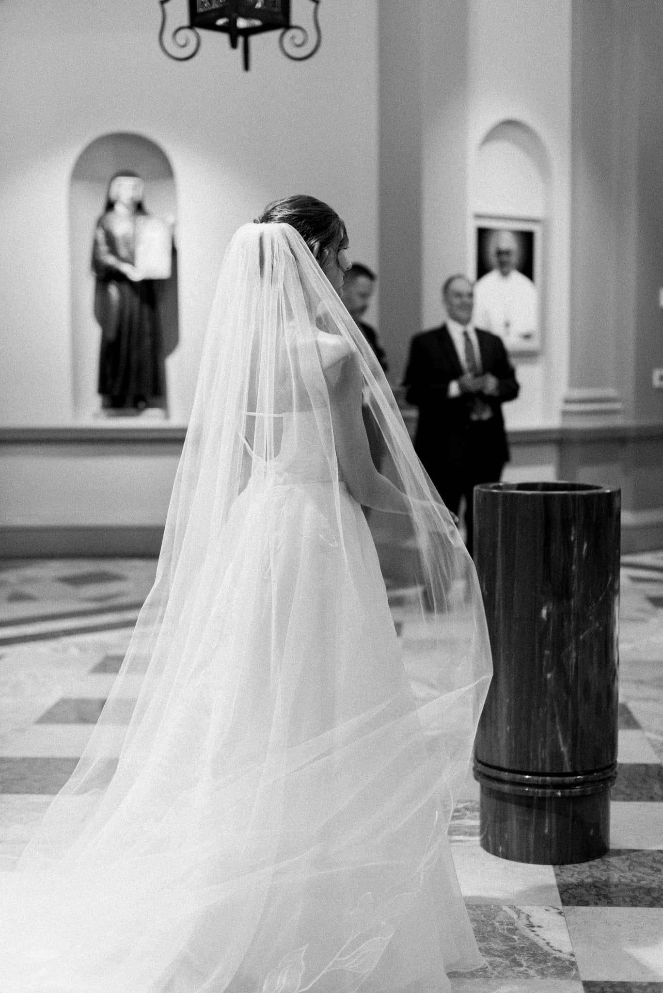 A flowing white bridal veil cascades elegantly in a series of wedding photographs taken in a church setting.
