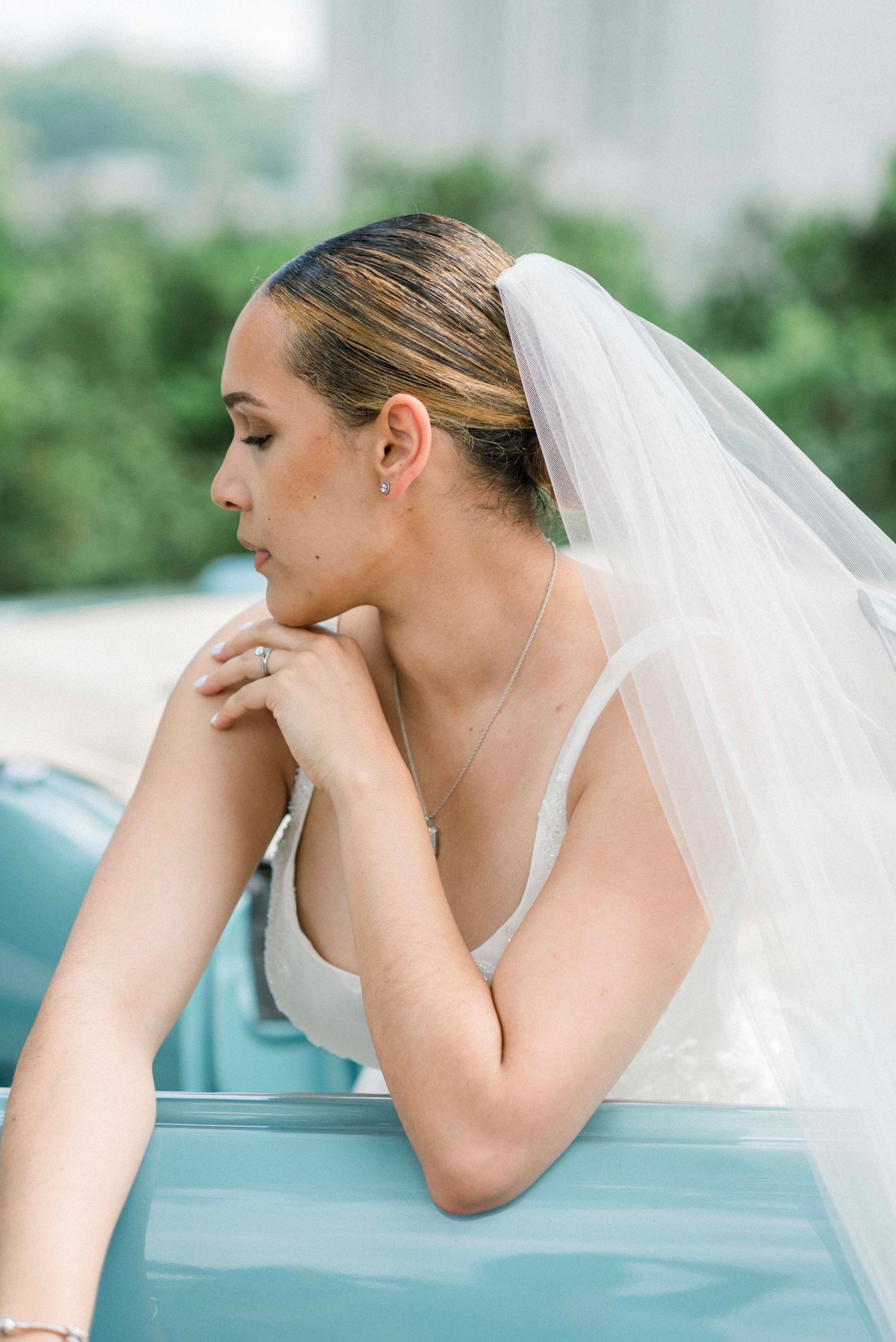 Artistic bridal portrait showing contemplative poses with a flowing veil.