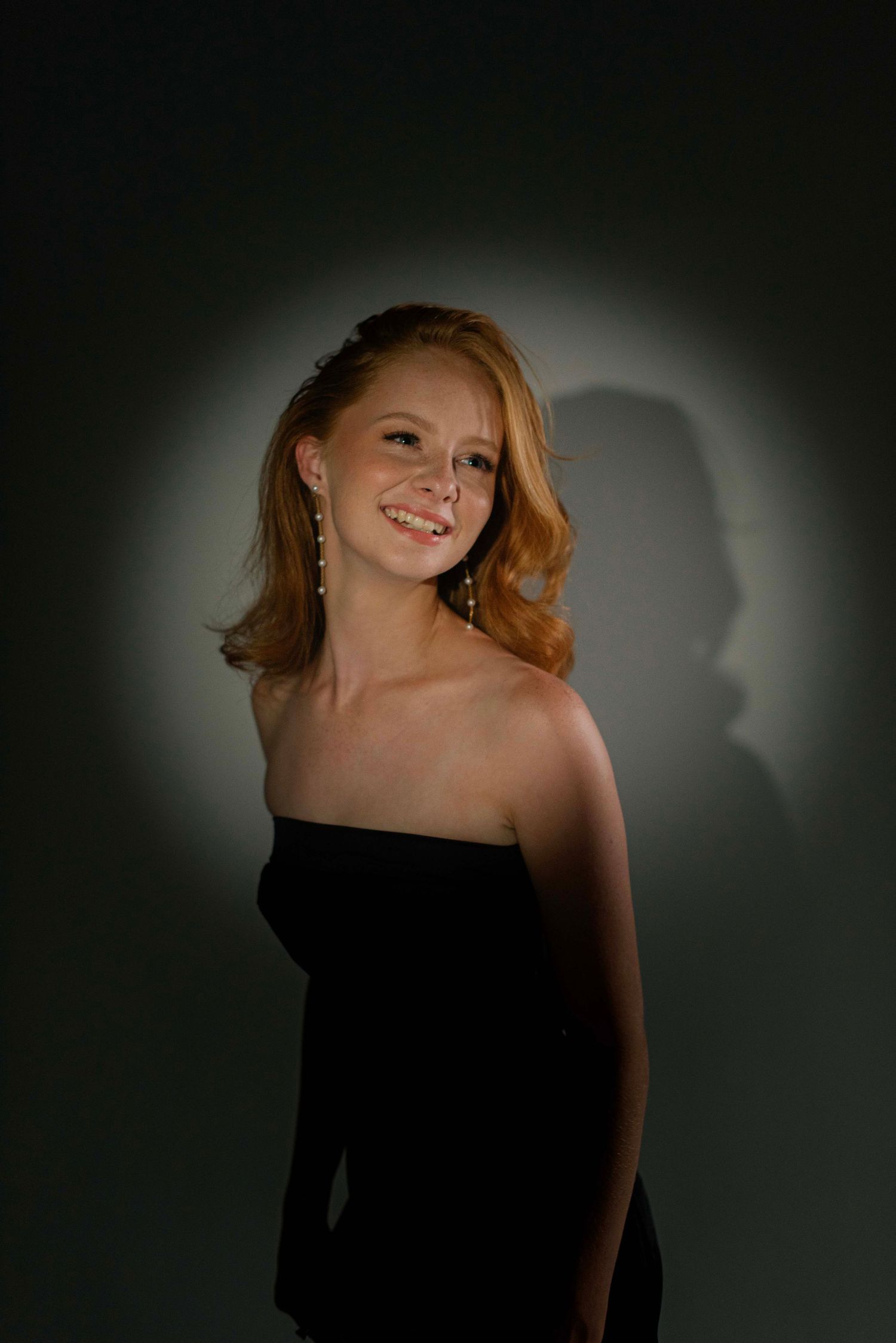 Artistic portrait series with dramatic lighting against a dark background.