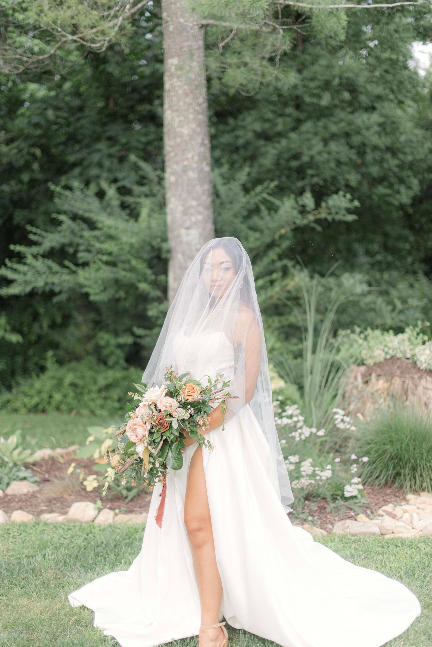 Series of romantic wedding portraits featuring a bride in a flowing white dress and veil in a lush garden setting.