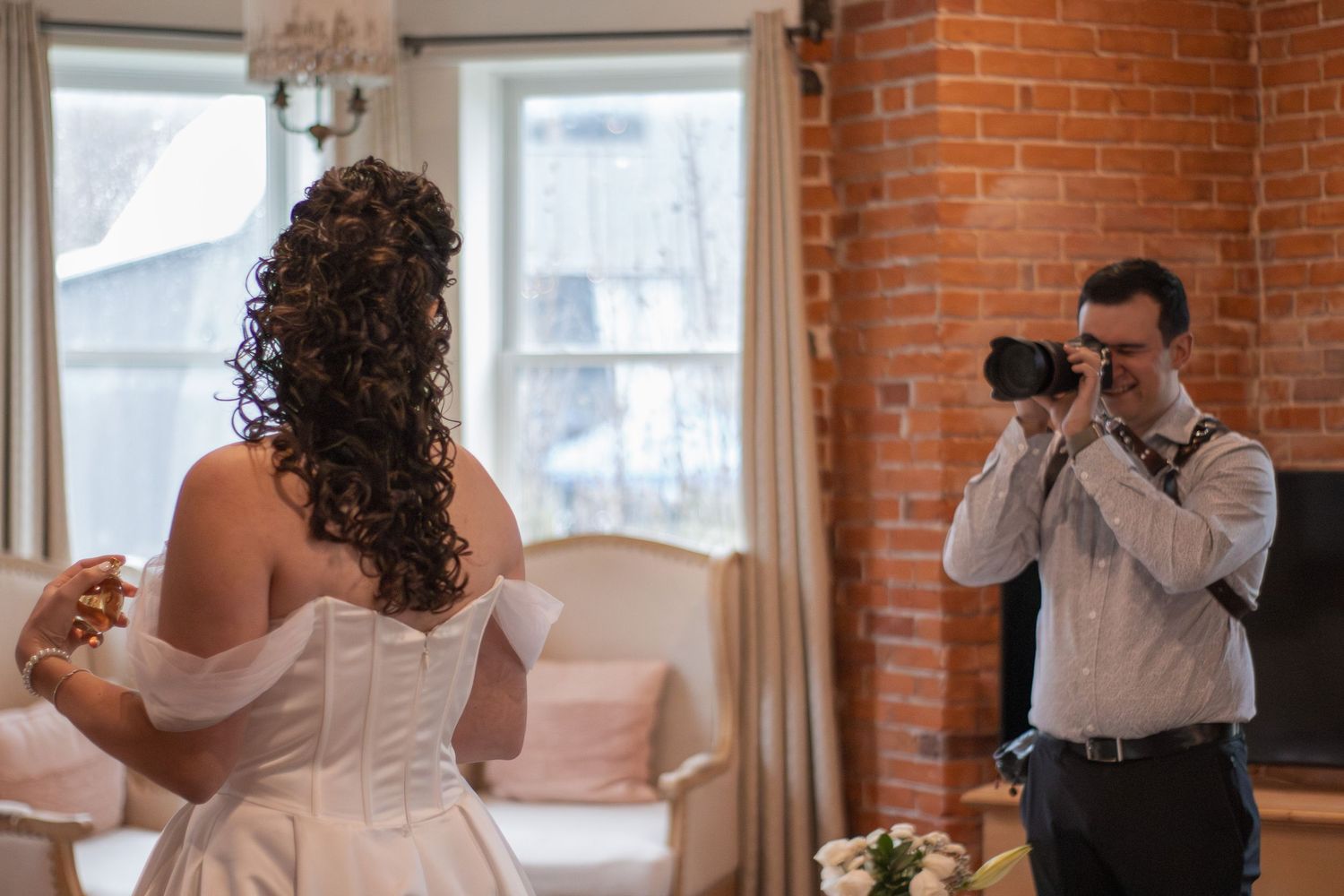 Photographer taking a photo of a bride