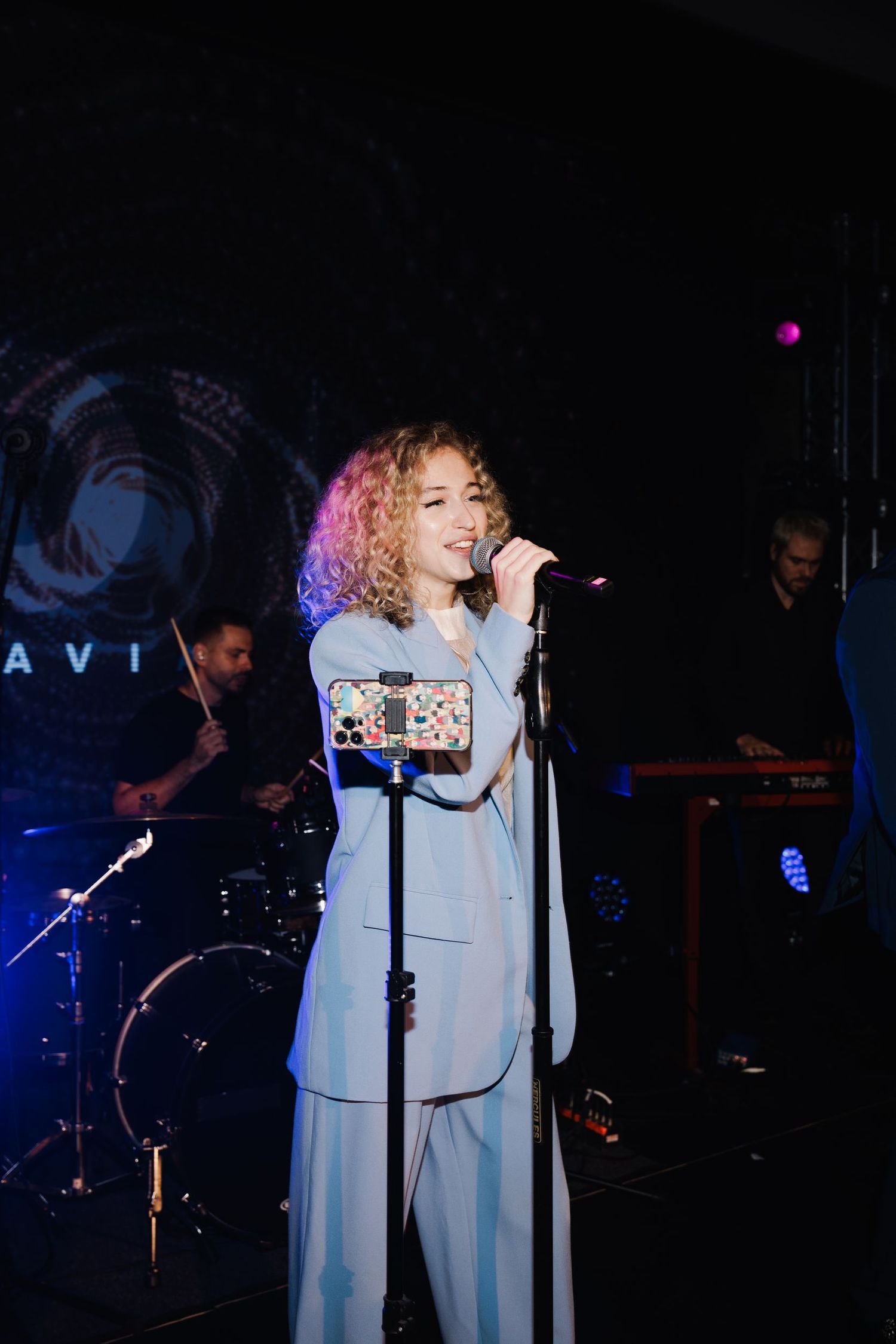 Live band performing at wedding reception with blue stage lighting.