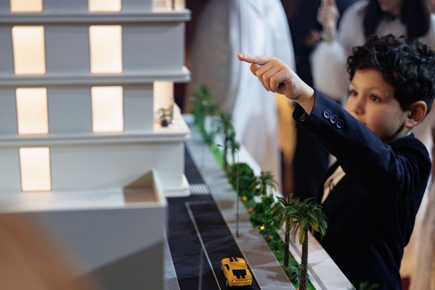 Young guest points at display while exploring interactive exhibit area.