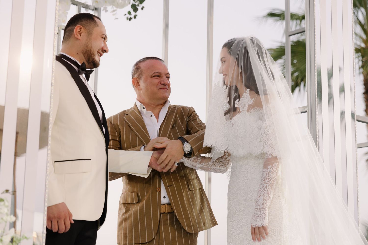 Wedding ceremony moment captured in an elegant white-decorated venue.