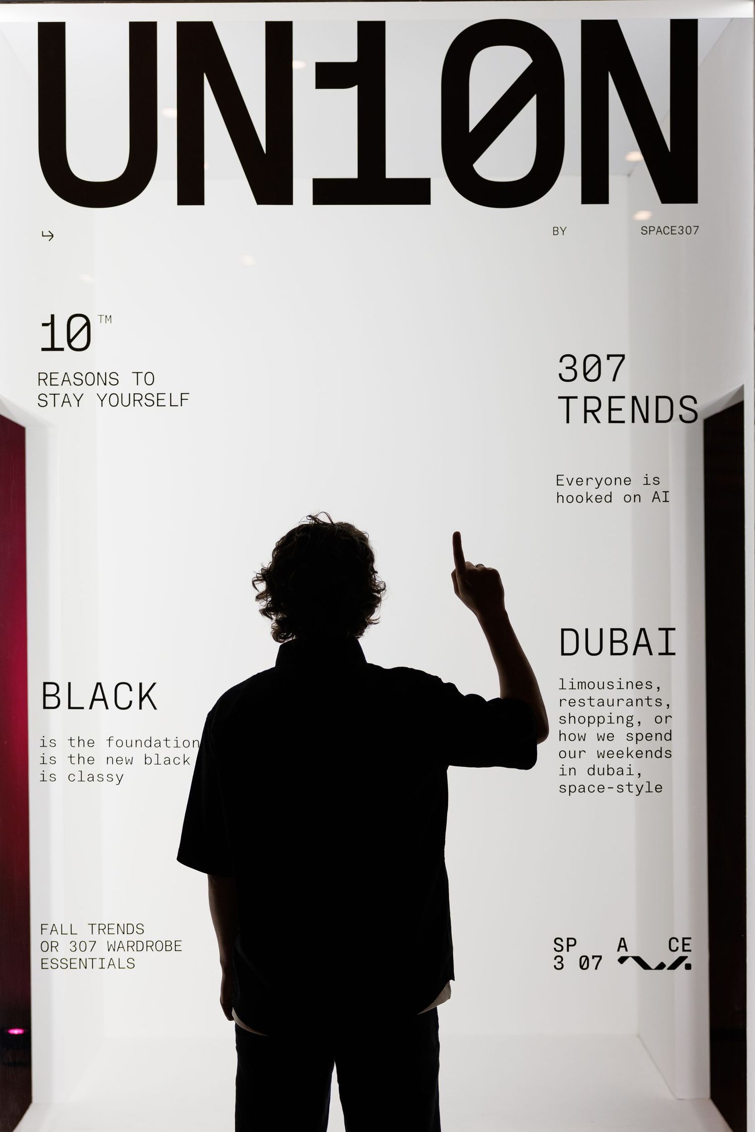 Minimalist design exhibition displays with backlit text panels showing 