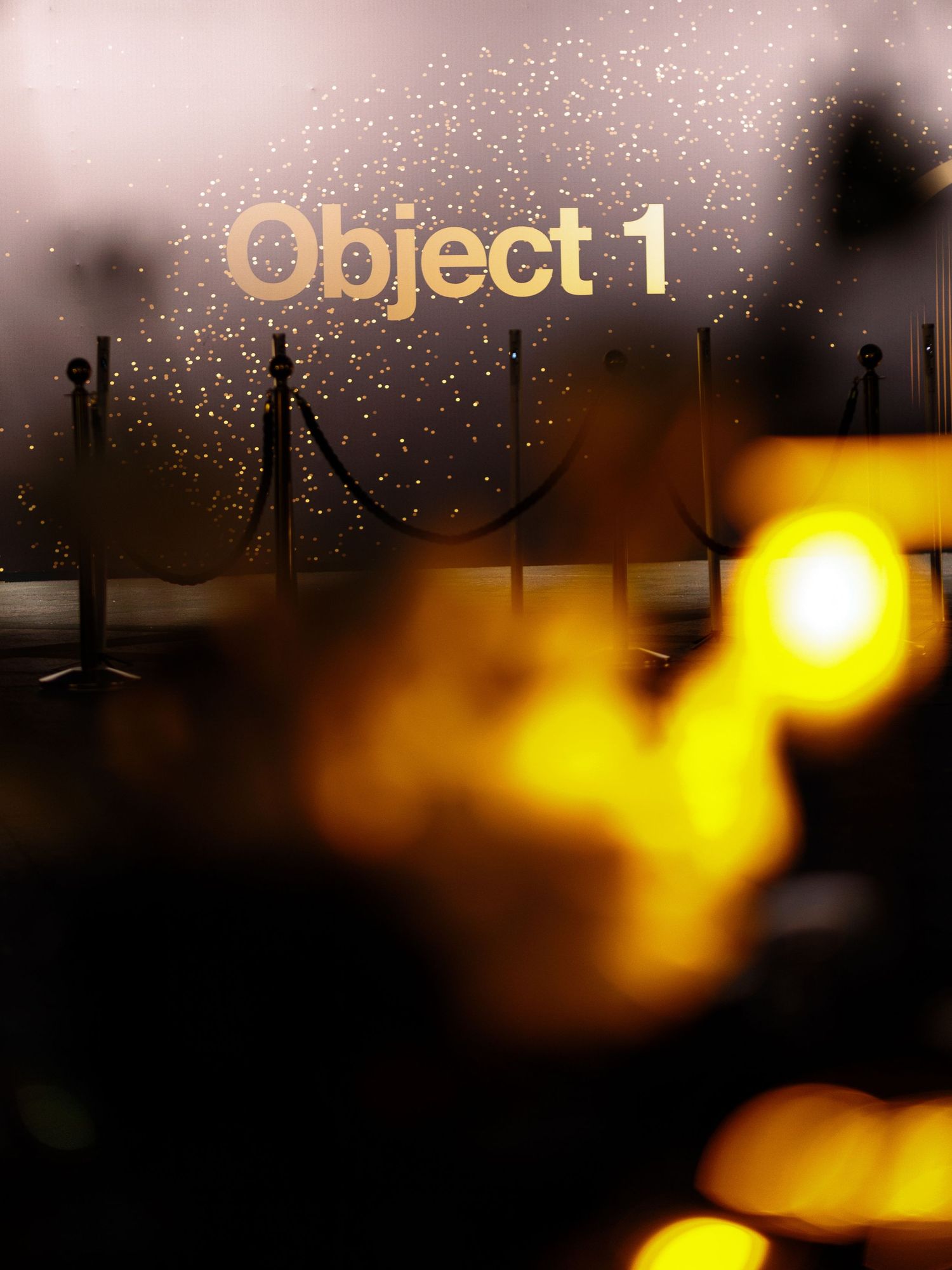 Abstract yellow and black background with sparkling lights and dark silhouettes creating a dramatic nighttime scene.