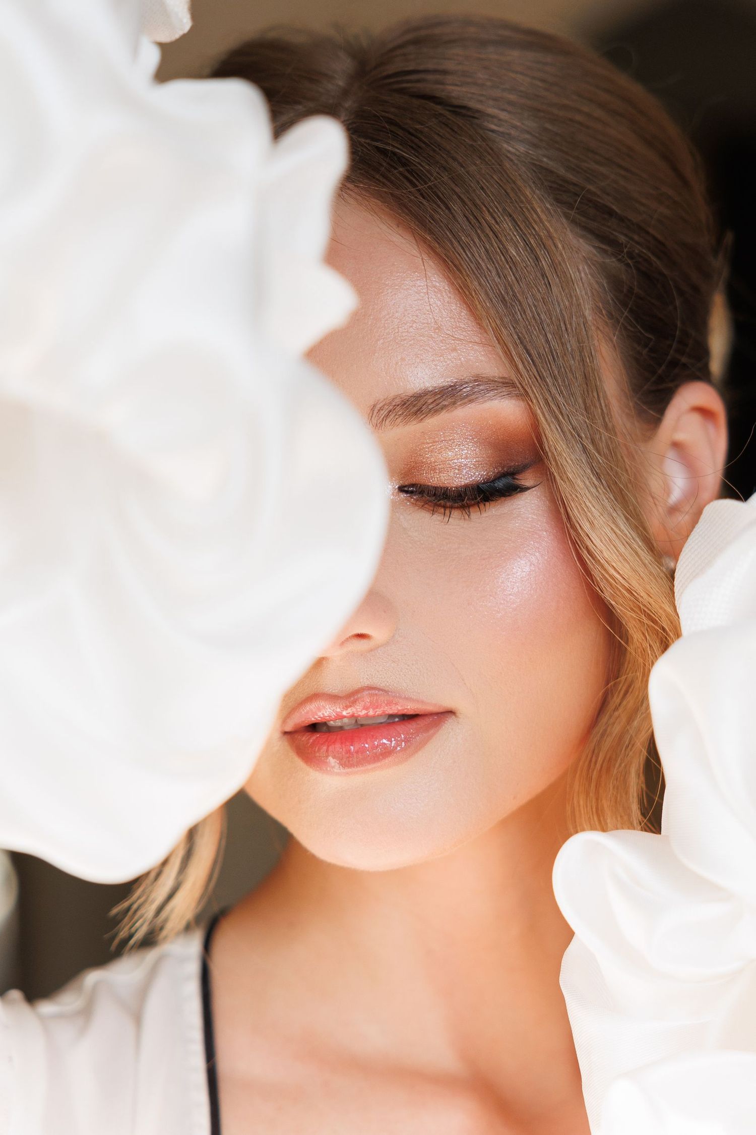 Artistic beauty shot showcasing soft makeup and dreamy lighting.