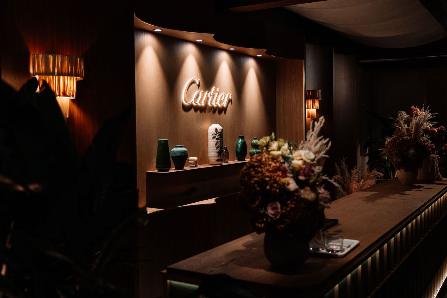 Elegant dark bar interior with warm lighting features sleek countertops and sophisticated decor details.