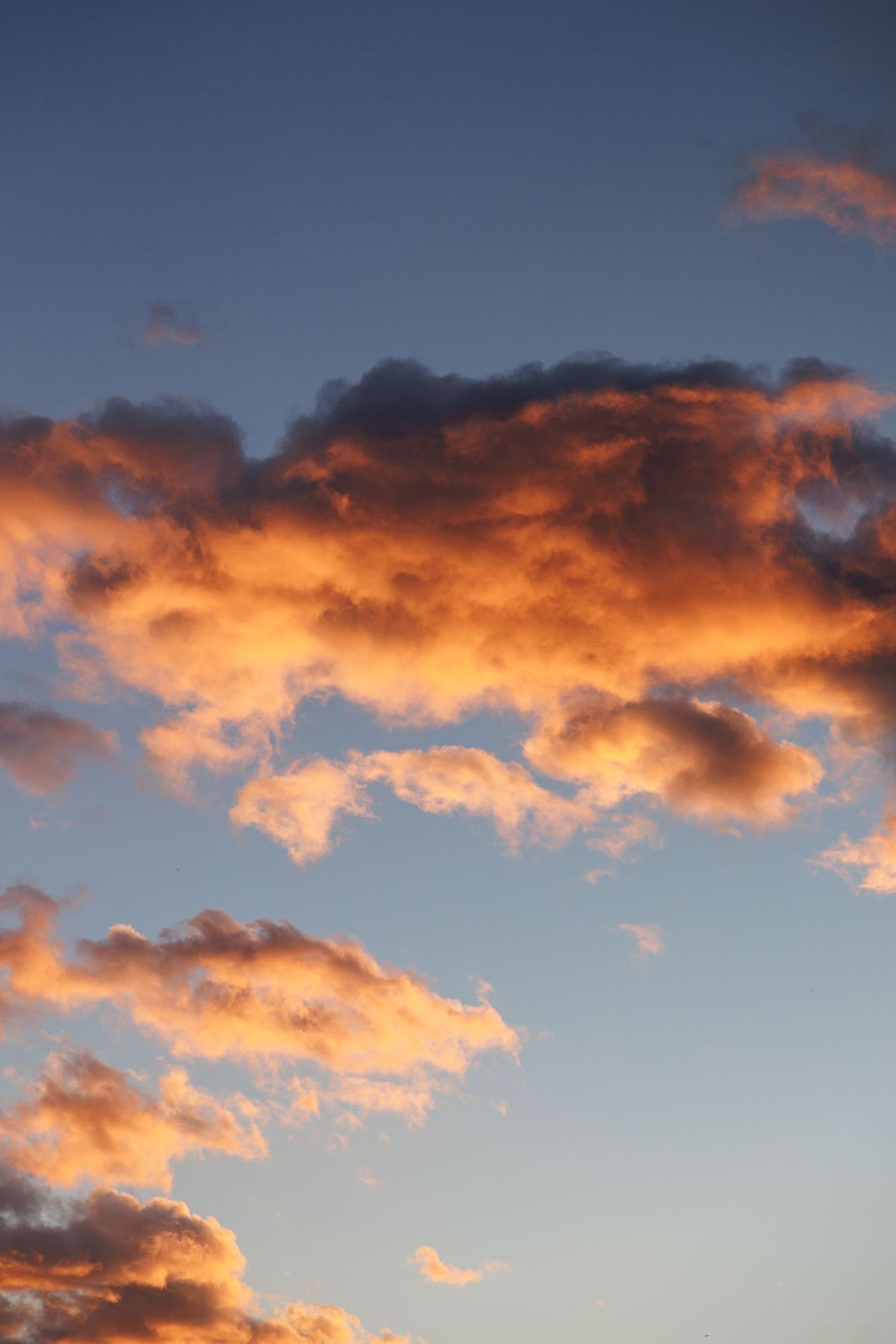 Dramatic orange and pink clouds illuminate the sky during sunset.