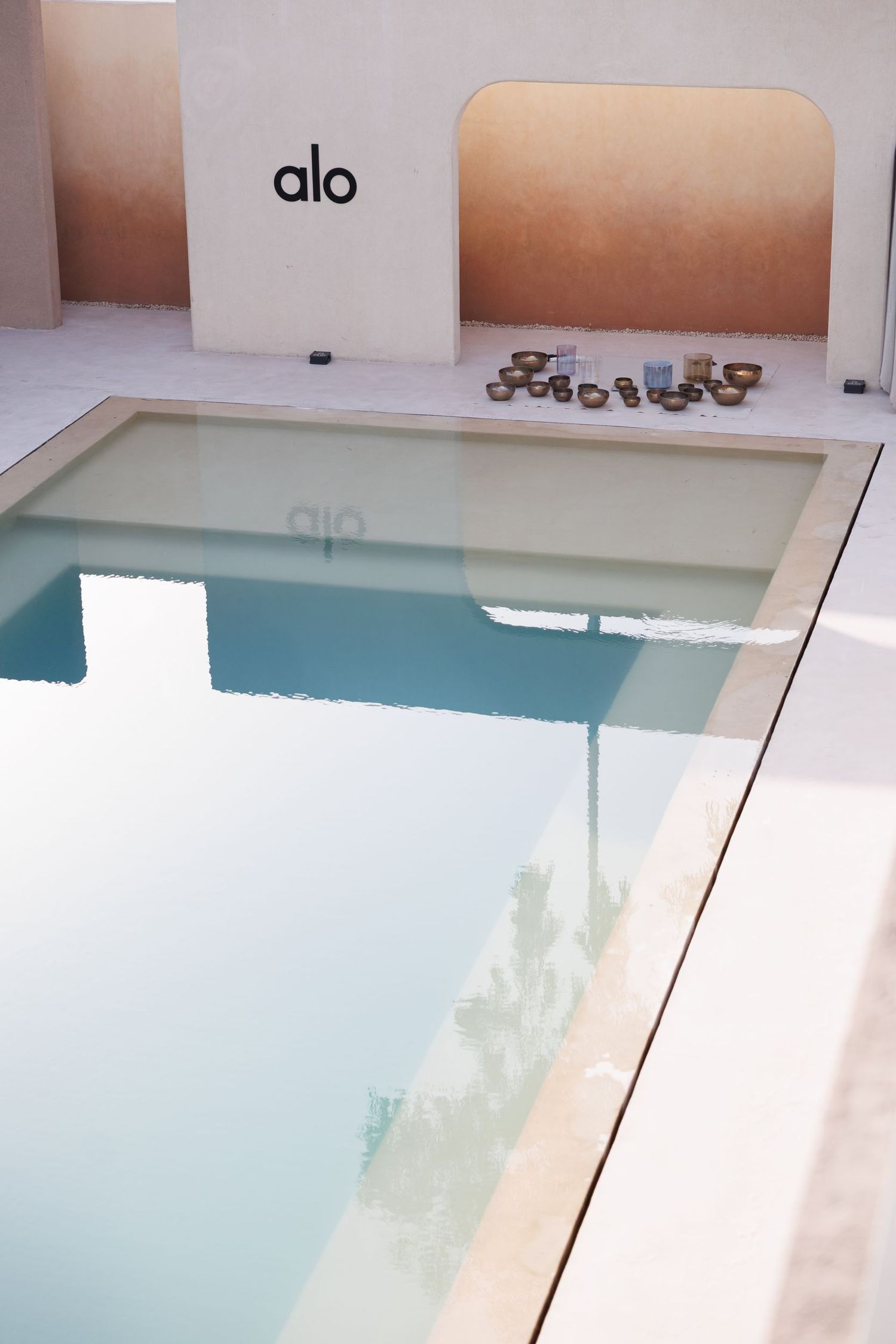 Modern minimalist pool area with clean white architecture and turquoise water.