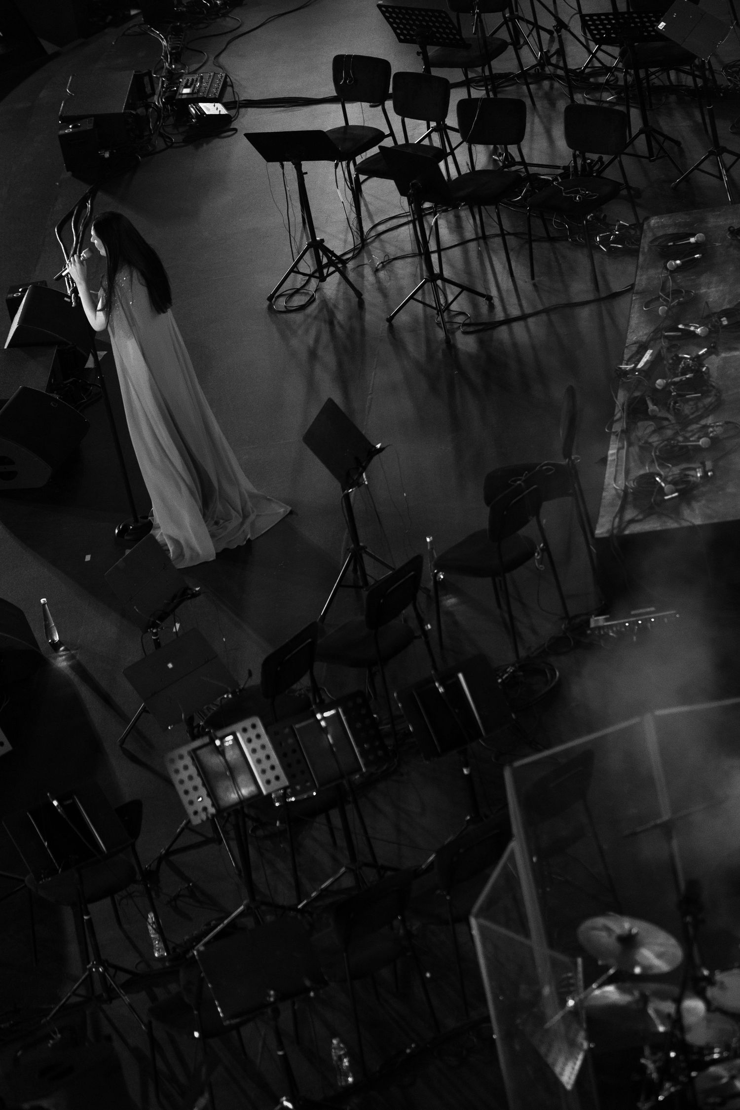 Overhead view of a dark event space with professional lighting and technical equipment setup.