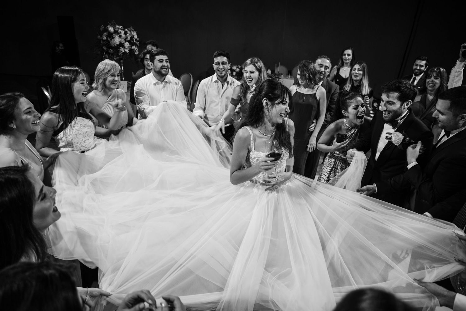 Black and white wedding reception dance floor filled with guests celebrating.