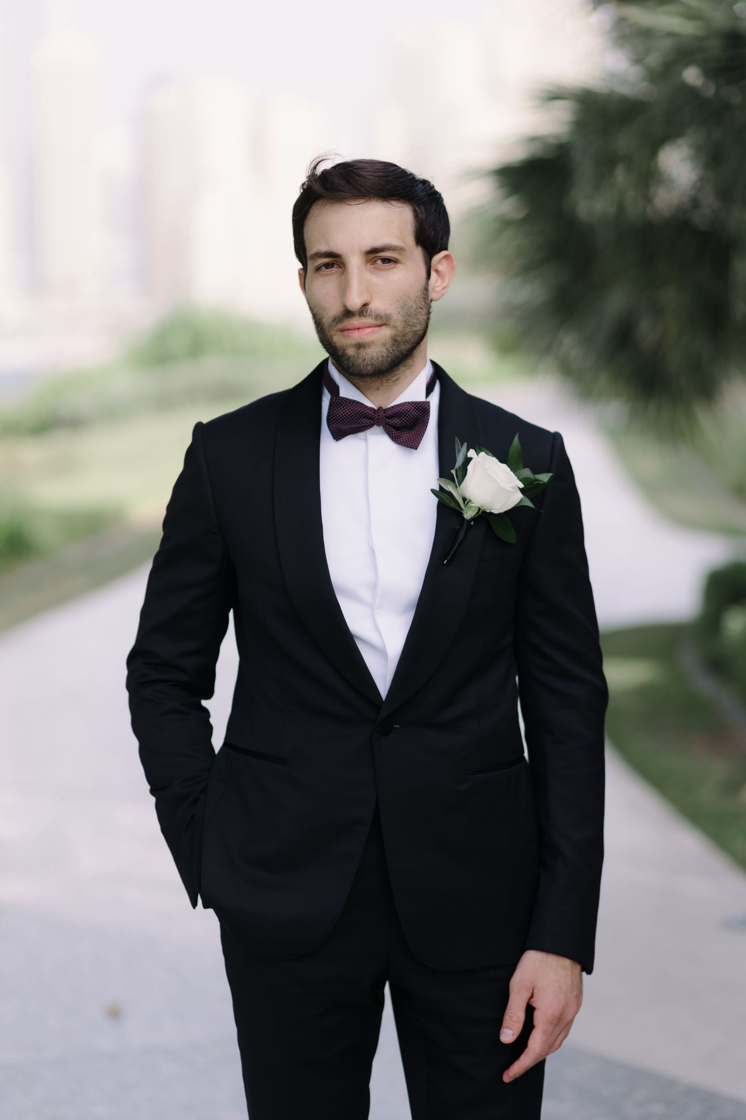 Classic black tuxedo with bow tie captured in an elegant wedding portrait.