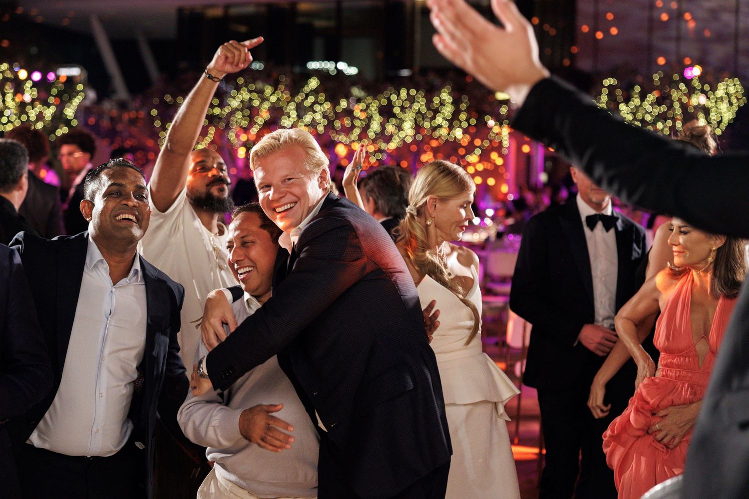 Lively dance floor scene at formal evening celebration with party guests.