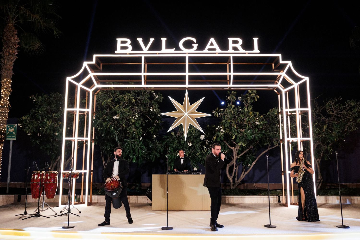 Luxury Bvlgari brand display with illuminated logo and velvet ropes in an elegant retail setting.