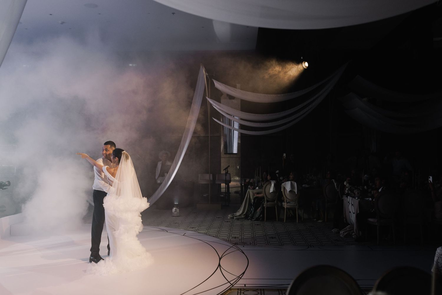 Atmospheric wedding dance floor scene with fog effects and dramatic lighting.