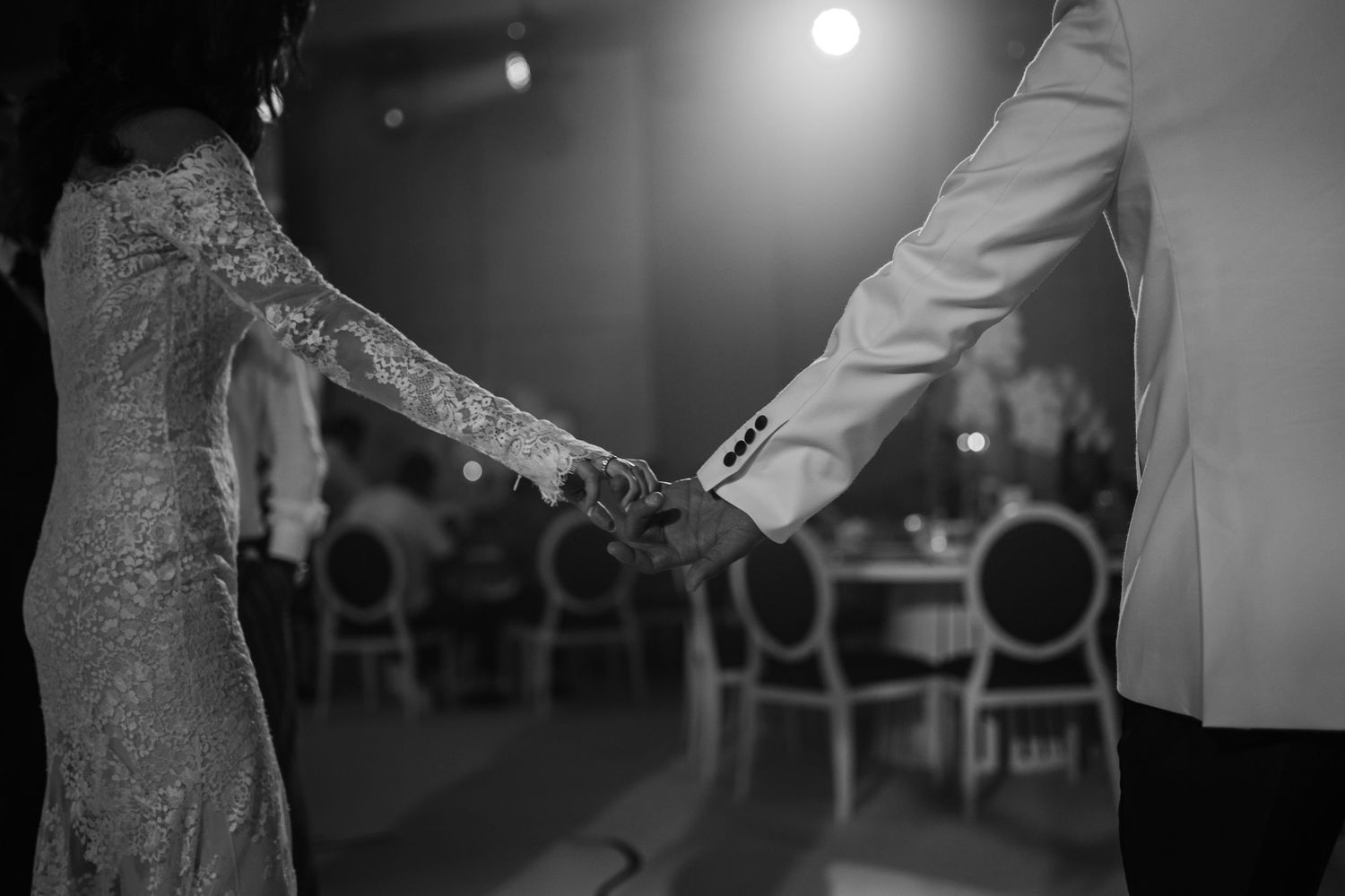 Black and white photo of couples dancing at an elegant wedding reception.