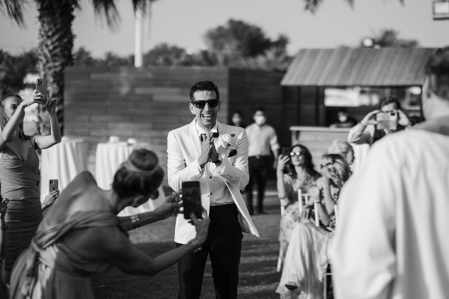 Candid moments of guests mingling at outdoor wedding reception.