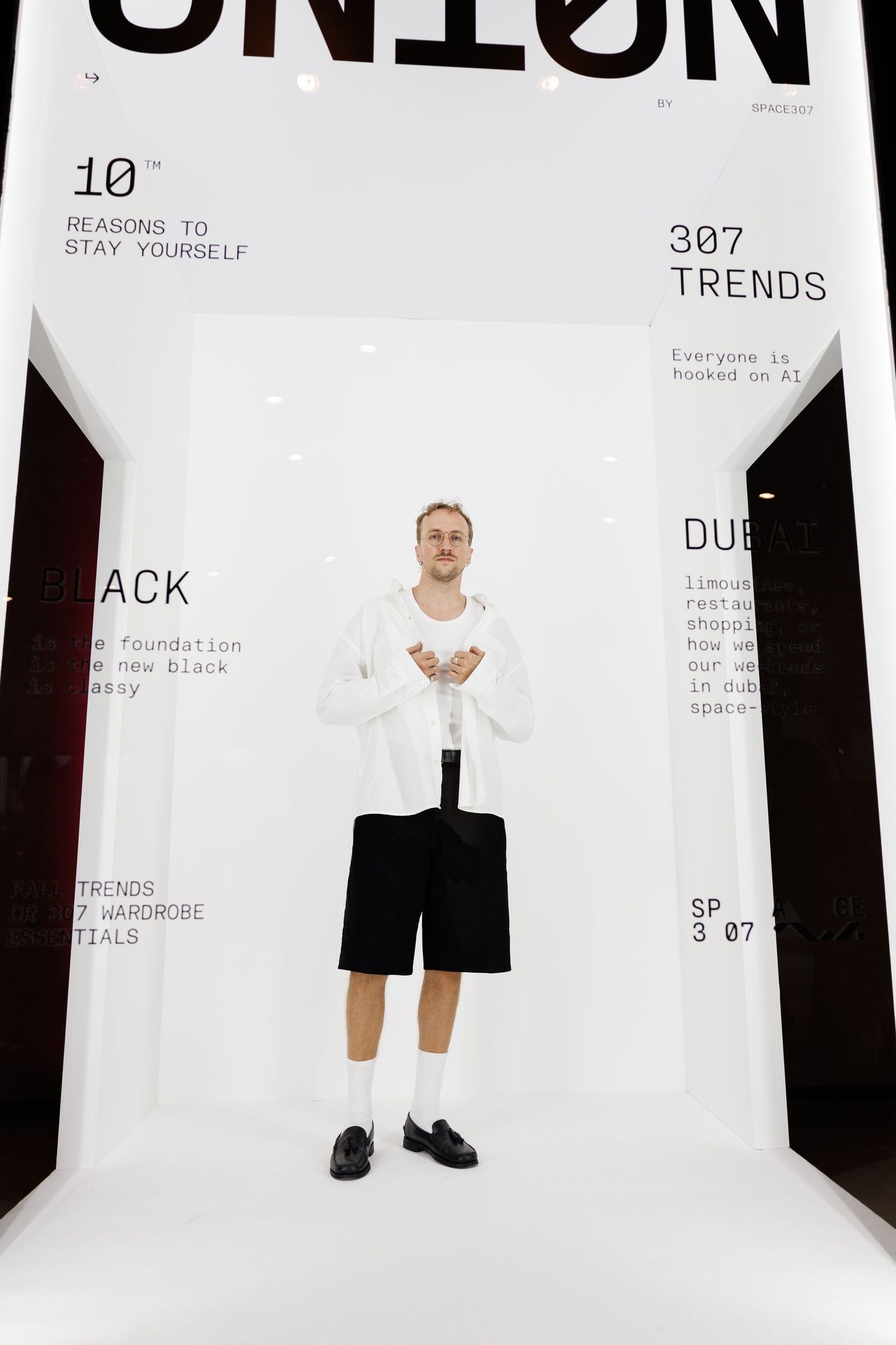 Clean white exhibition space with typography and modern design elements.