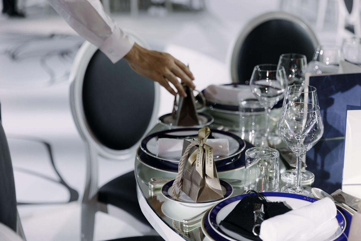 Wedding reception table settings with navy blue and white color scheme.