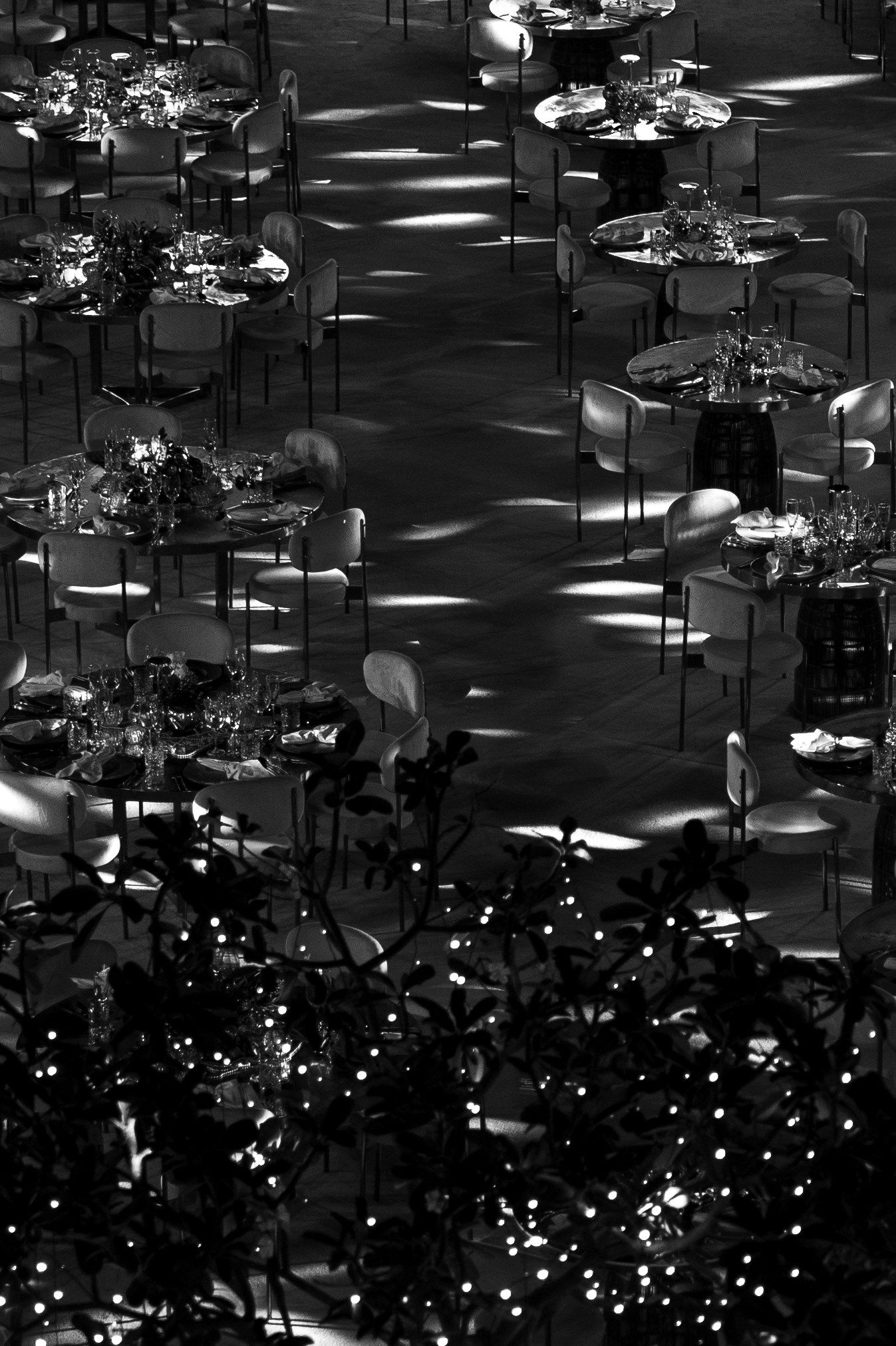 Abstract black and white chandelier installation creating dramatic lighting patterns.