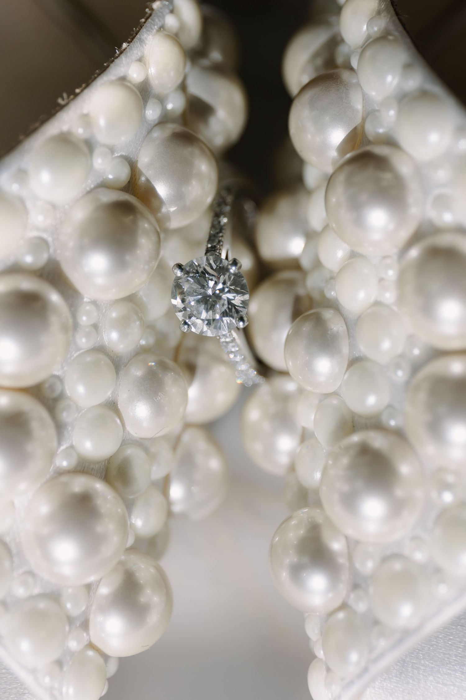 Close-up of pearl and crystal wedding accessories with sparkling details.