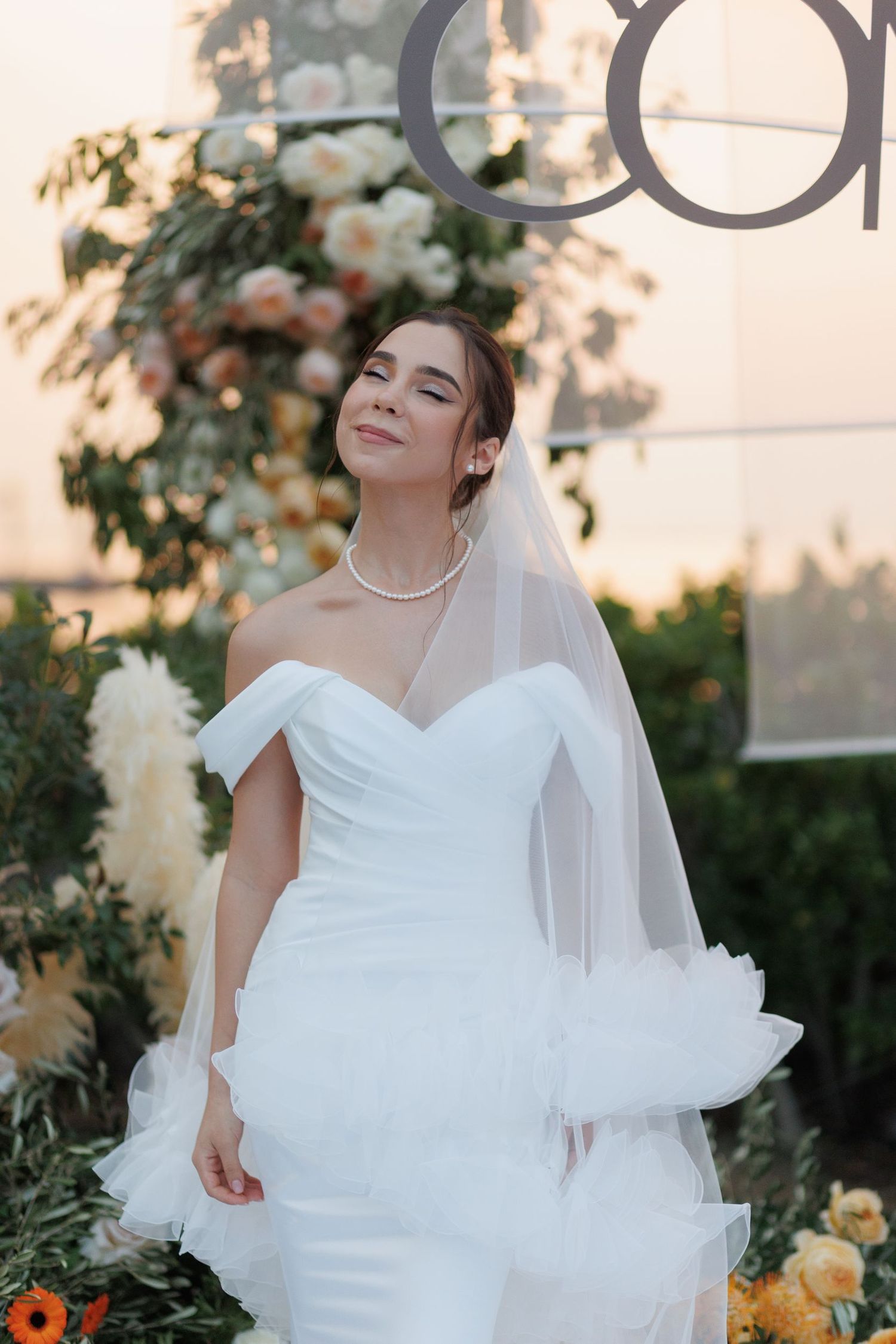 Elegant bridal portraits captured at golden hour in a garden with yellow flowers.