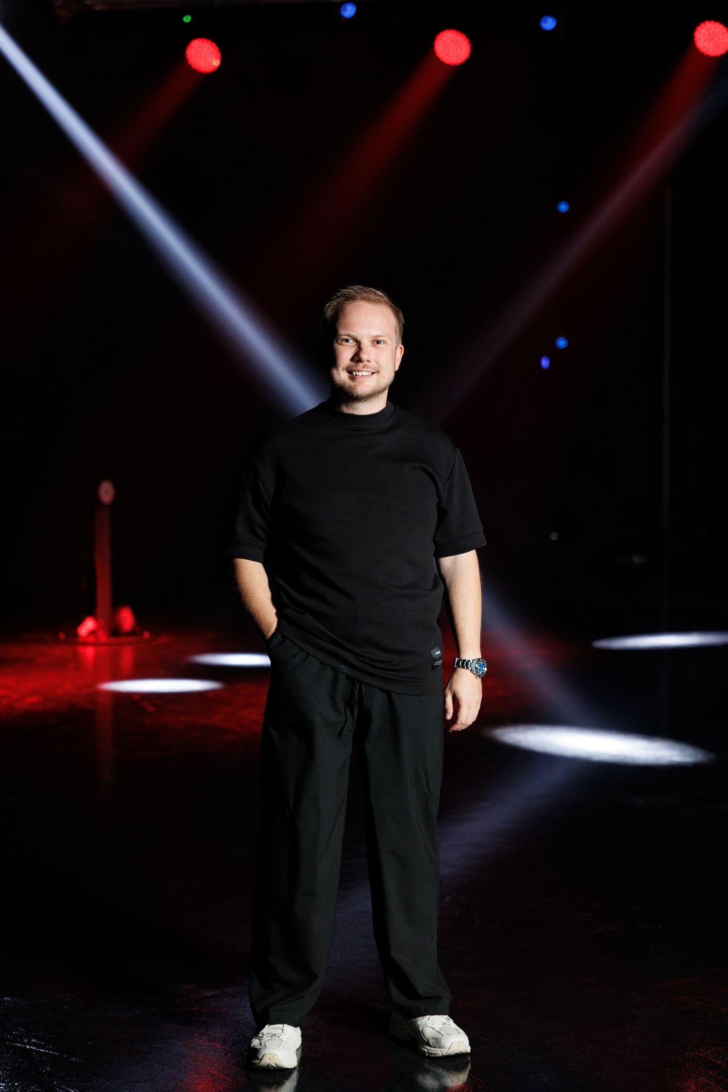 Stage performance with dramatic spotlights creating contrast against a dark background.