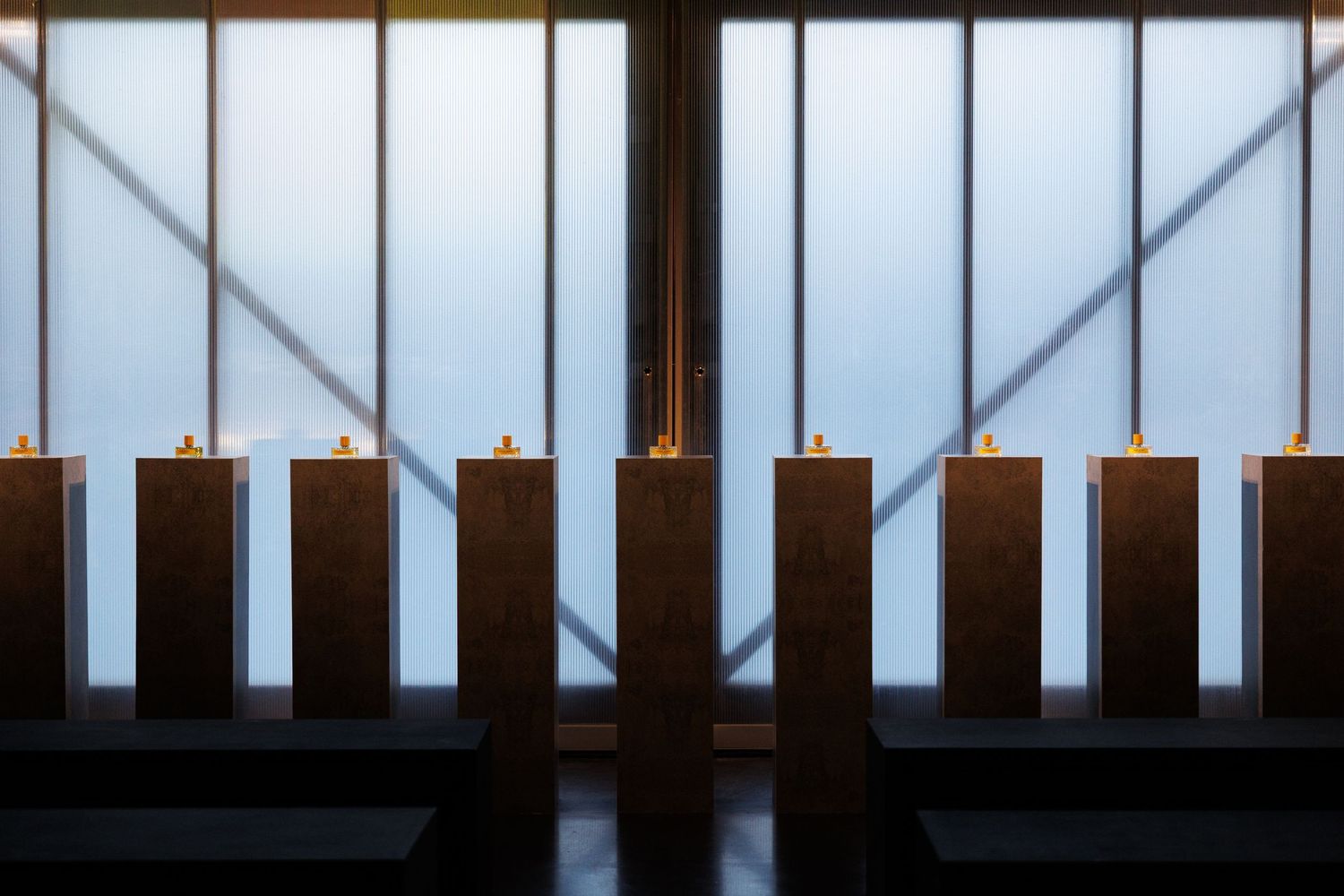 Modern interior with vertical window panels creating geometric light patterns.