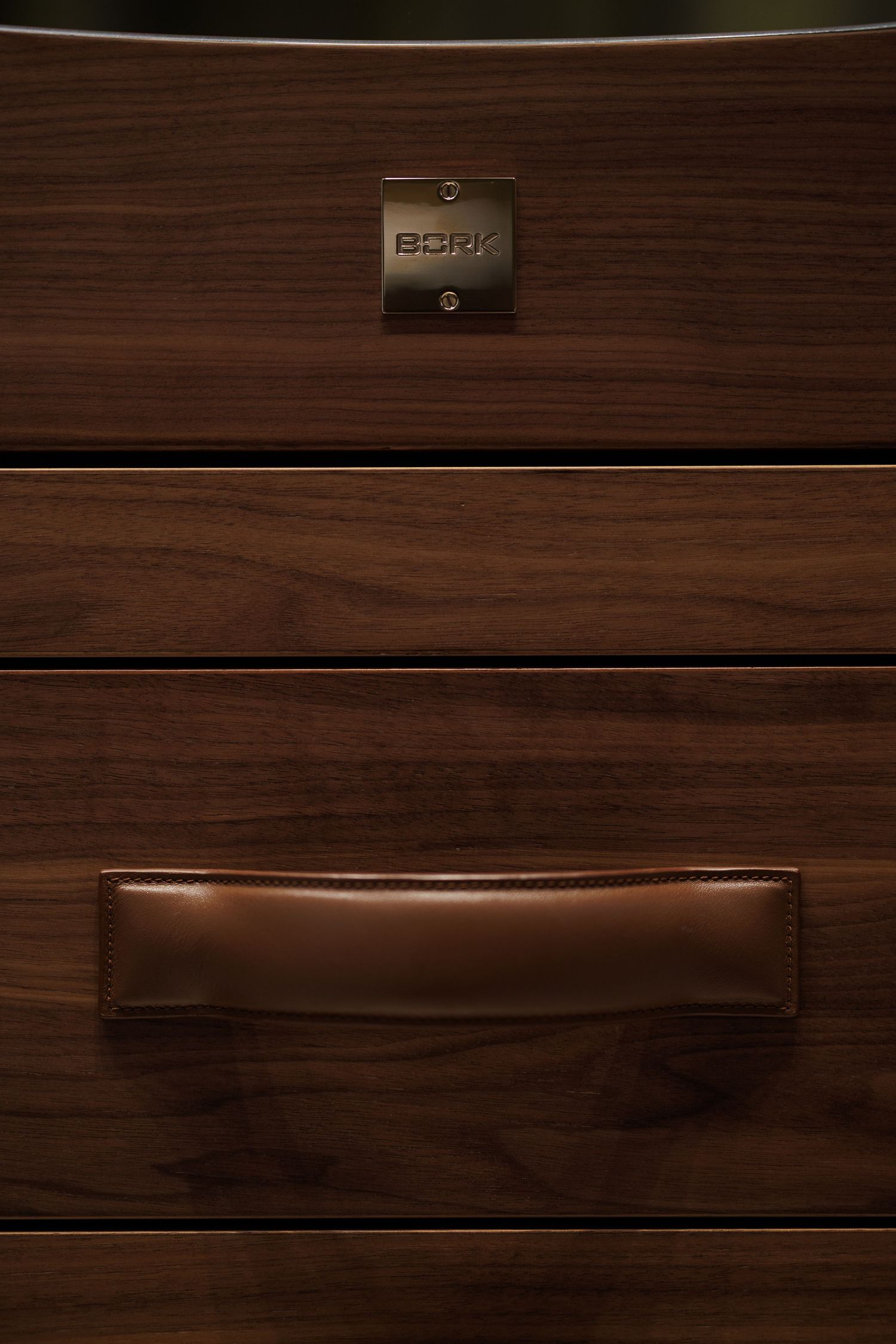 Dark wood paneled wall texture with horizontal grain pattern and metal fixtures.