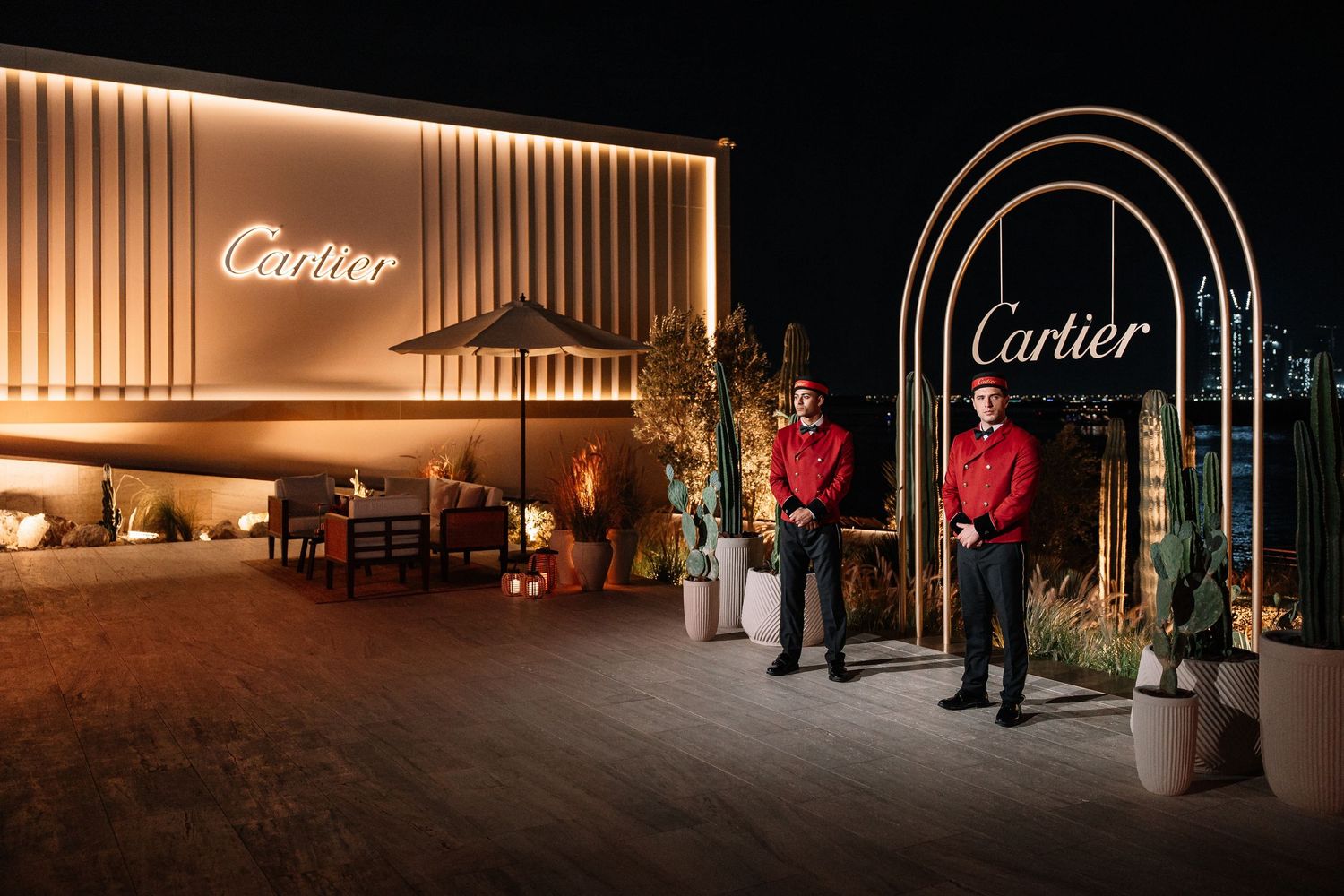 Illuminated luxury retail storefront with modern lighting design and elegant architectural features.