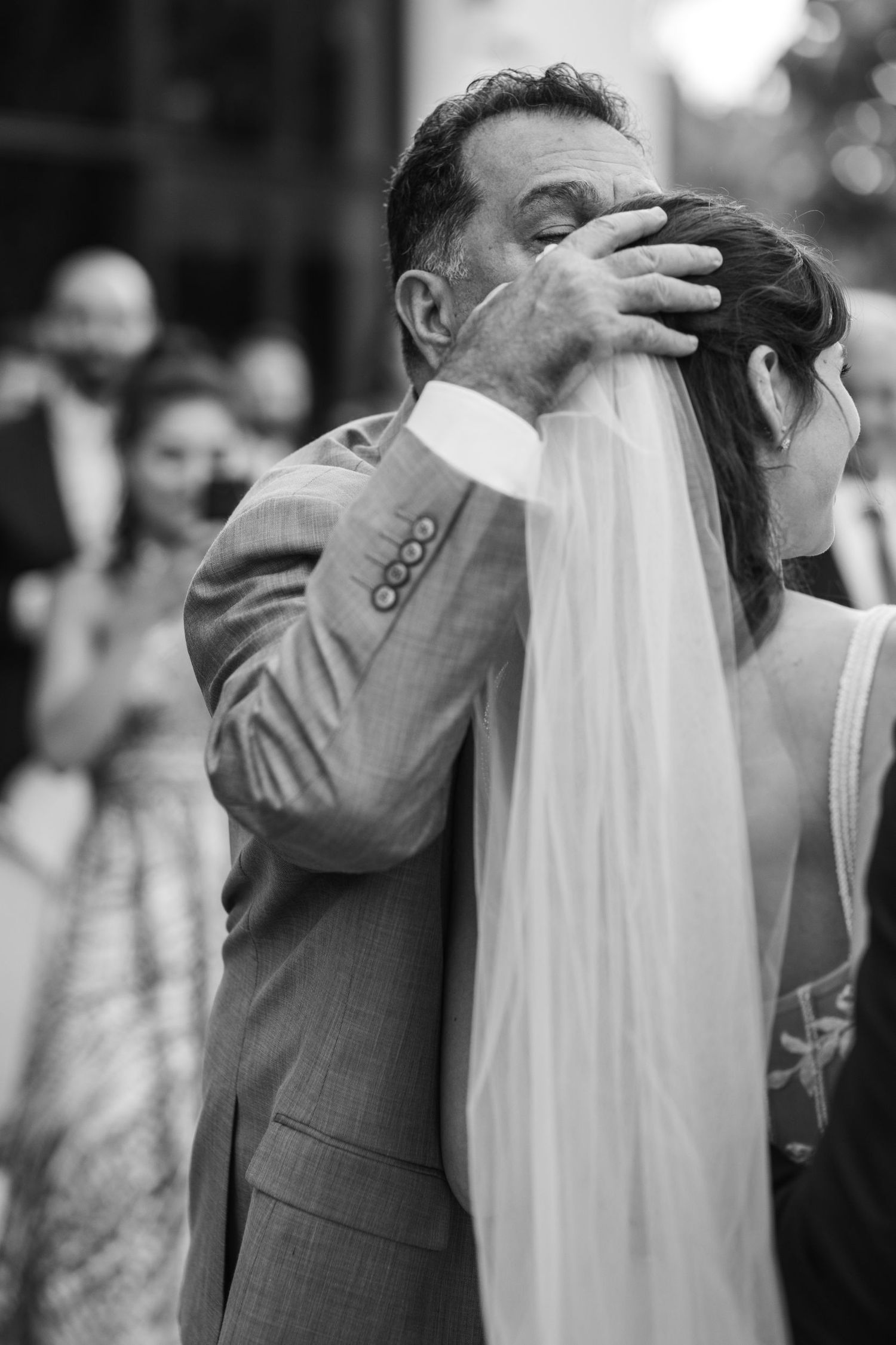 Black and white photo of an emotional first look moment at a wedding ceremony.