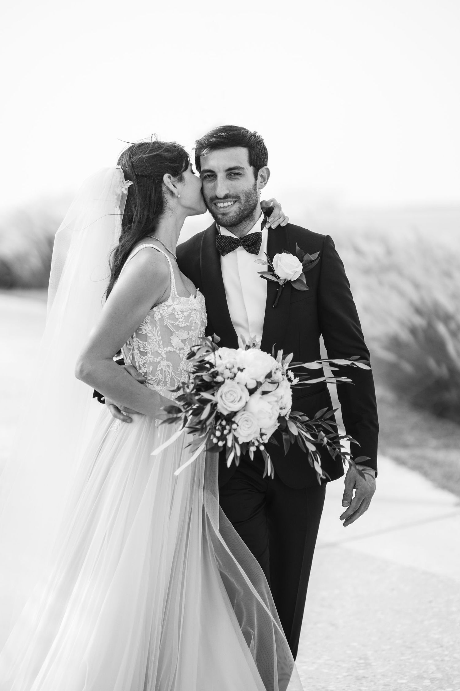 Black and white wedding photos showing tender moments between newlyweds.