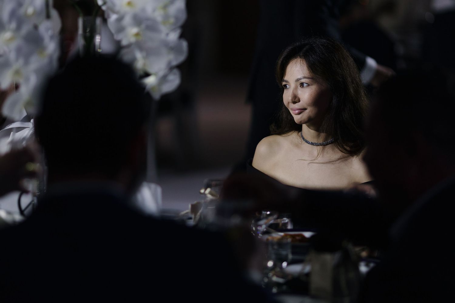 Dramatic low-light wedding reception scene with elegant decor and lighting effects.