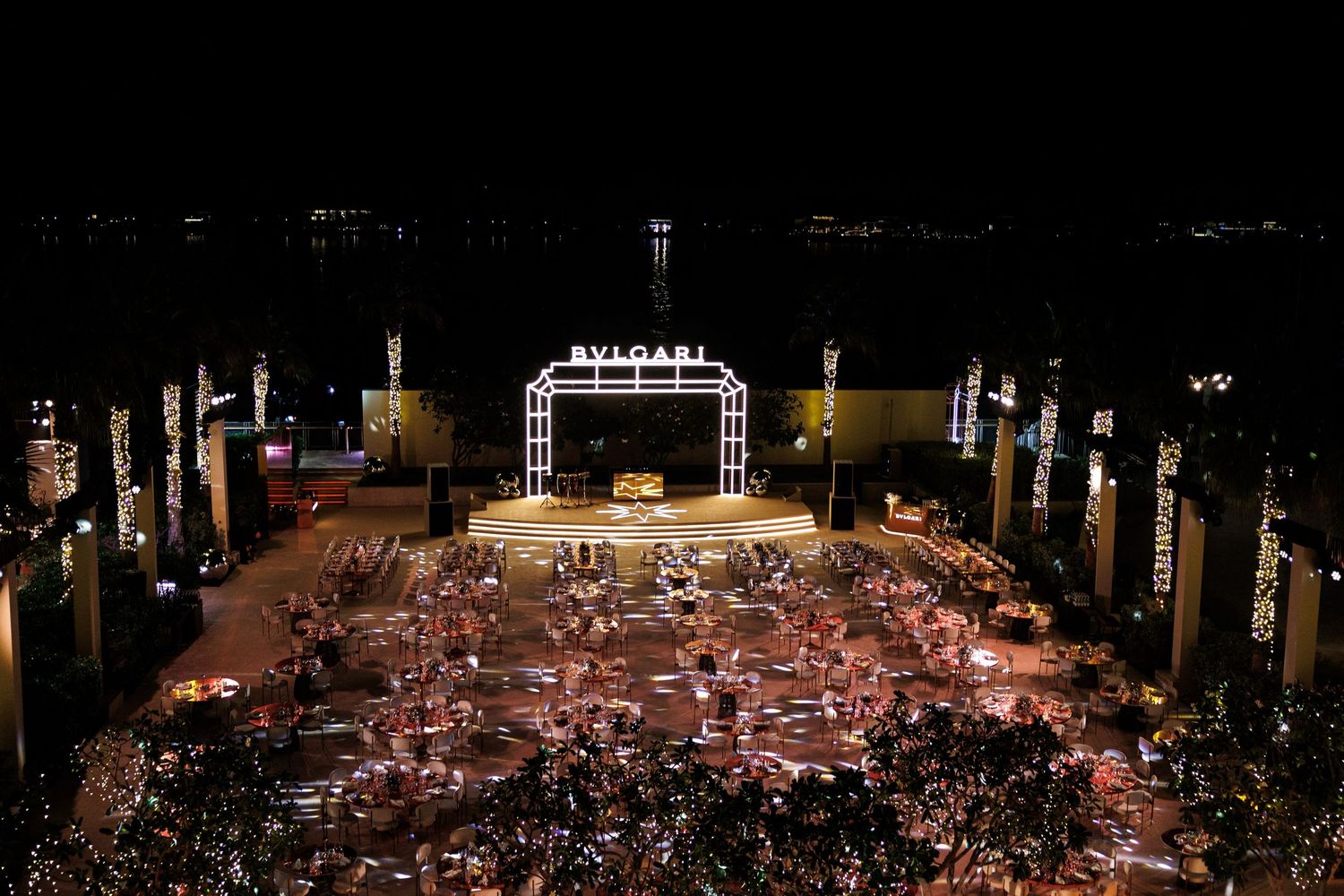 Aerial view of a grand outdoor event space with elaborate seating arrangements.
