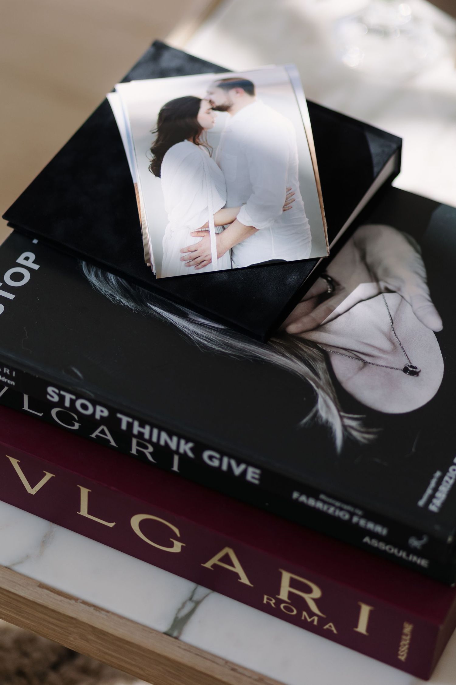 A collection of fashion and lifestyle books stacked together with artistic photography.