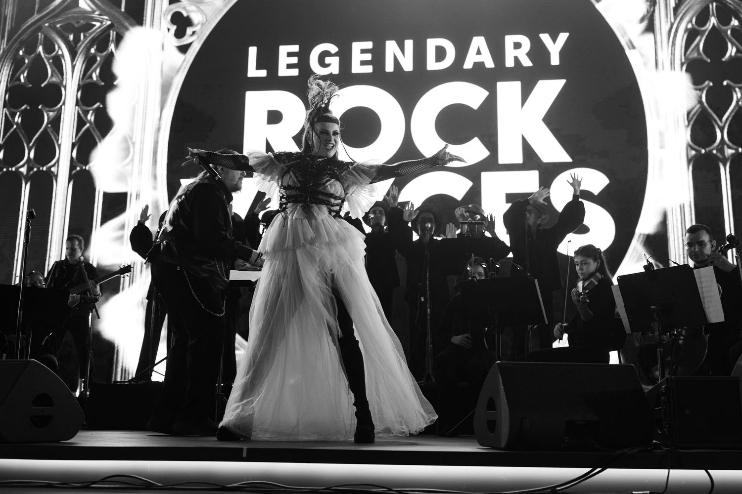 Large event space with 'LEGENDARY ROCK' text displayed on illuminated screens.
