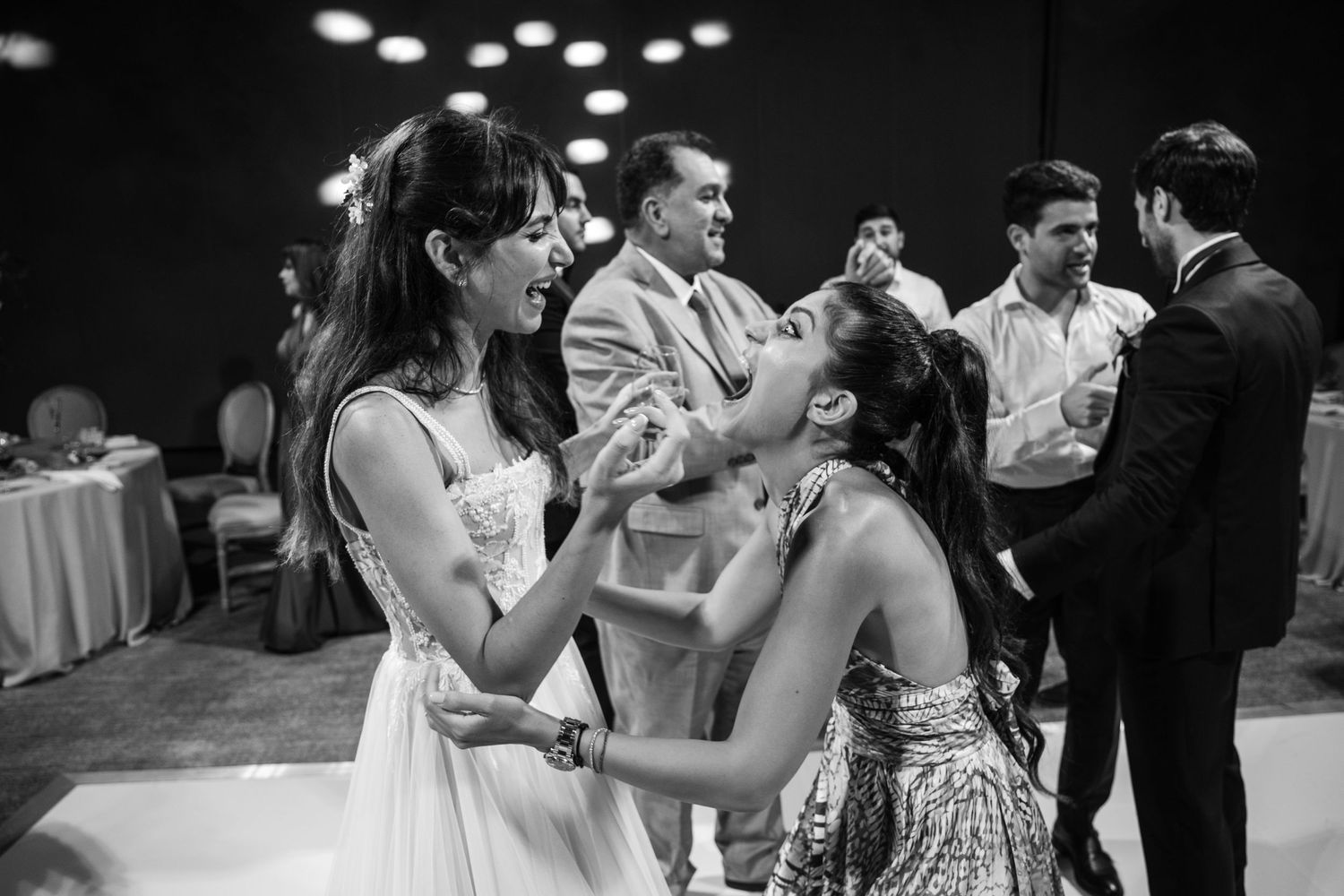 Wedding guests share an intimate moment on the dance floor during the celebration.
