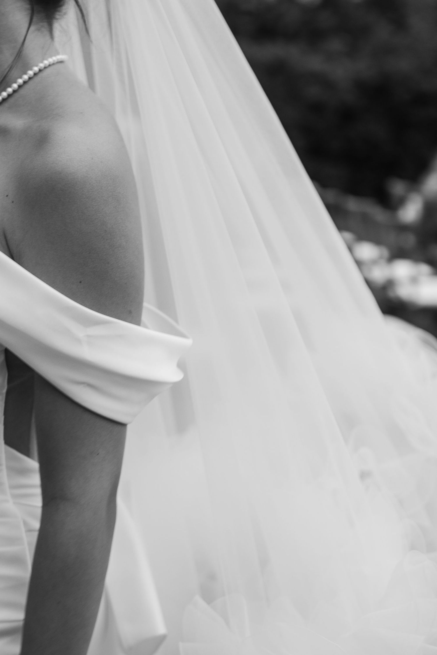 Elegant flowing white bridal veil detail in black and white.