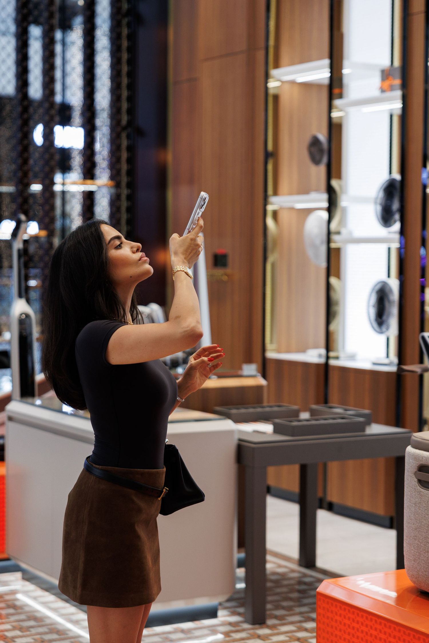 Interior of a modern retail store with illuminated display cases and wood paneling.