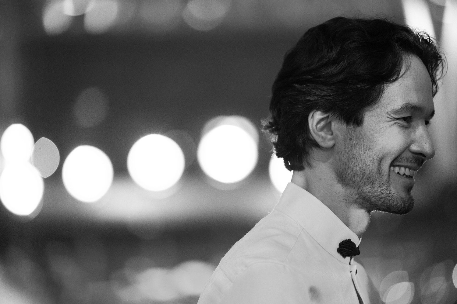 Black and white portrait shot capturing joyful expressions during a performance.