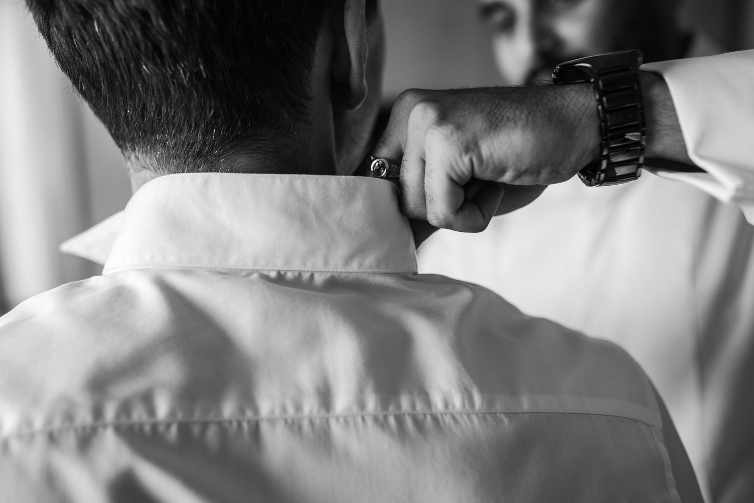 Close-up black and white detail of formal dress shirt collars.