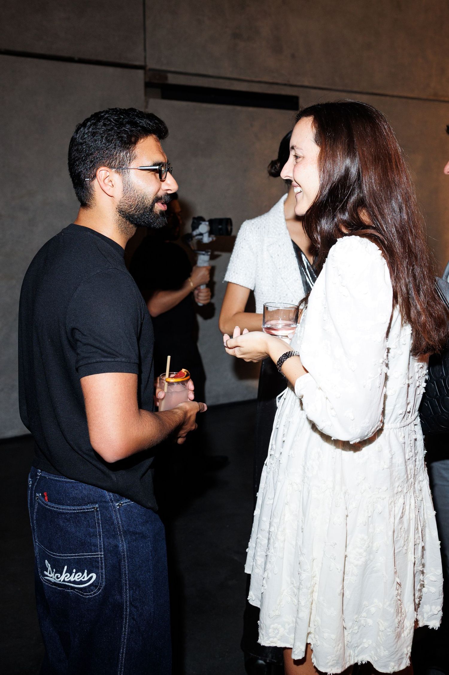 Two people engaged in animated conversation at a social gathering.