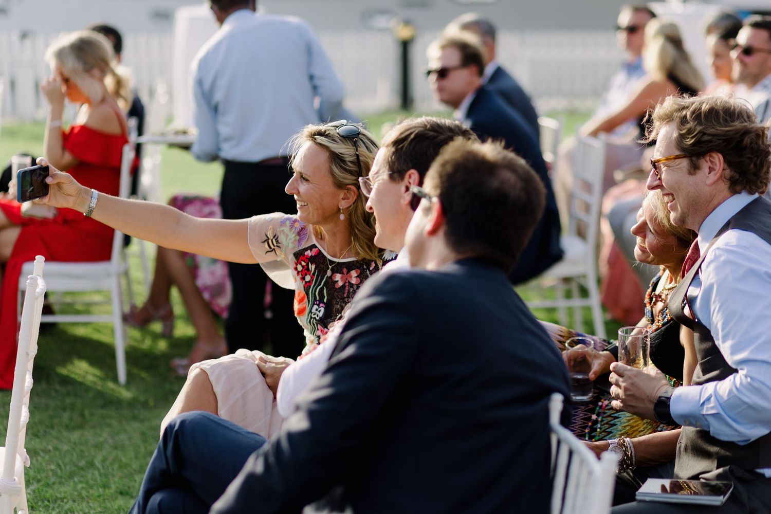 Wedding guests seated outdoors enjoying the celebration.