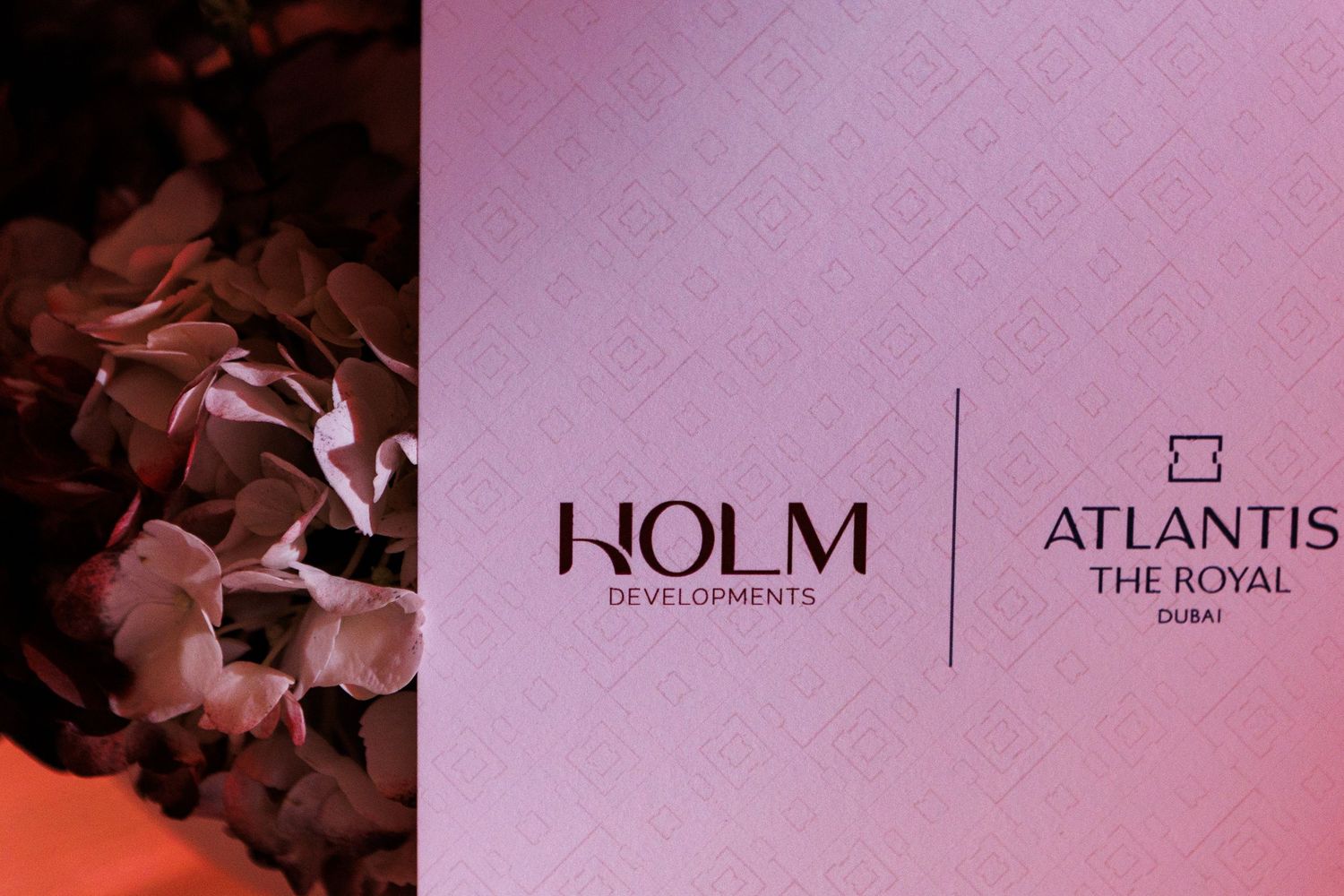 Corporate event branding display showing HOLM and Atlantis The Royal logos.