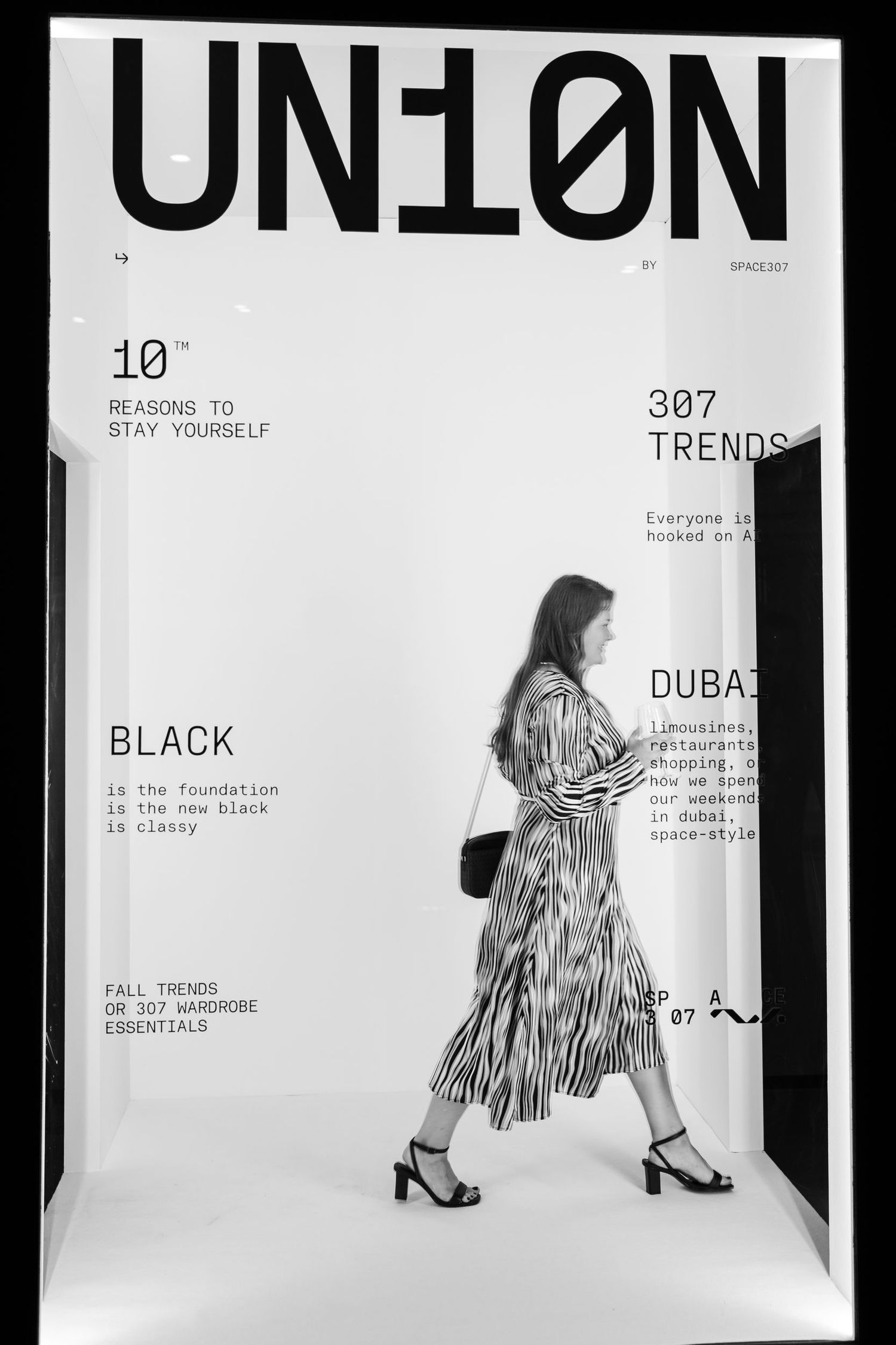 Fashion display area with white walls featuring black text and minimalist design.