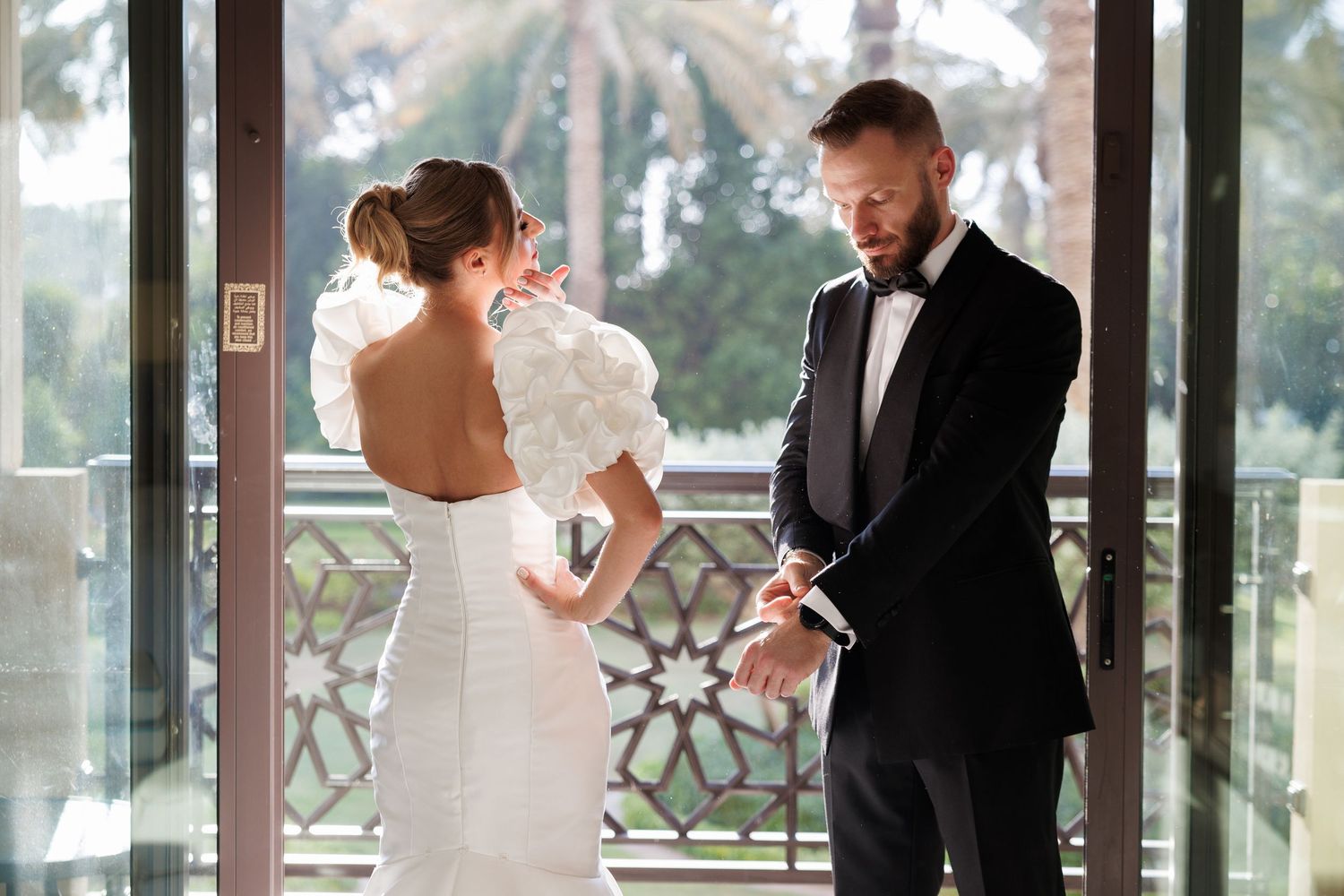 Wedding couple sharing intimate moment on outdoor terrace.